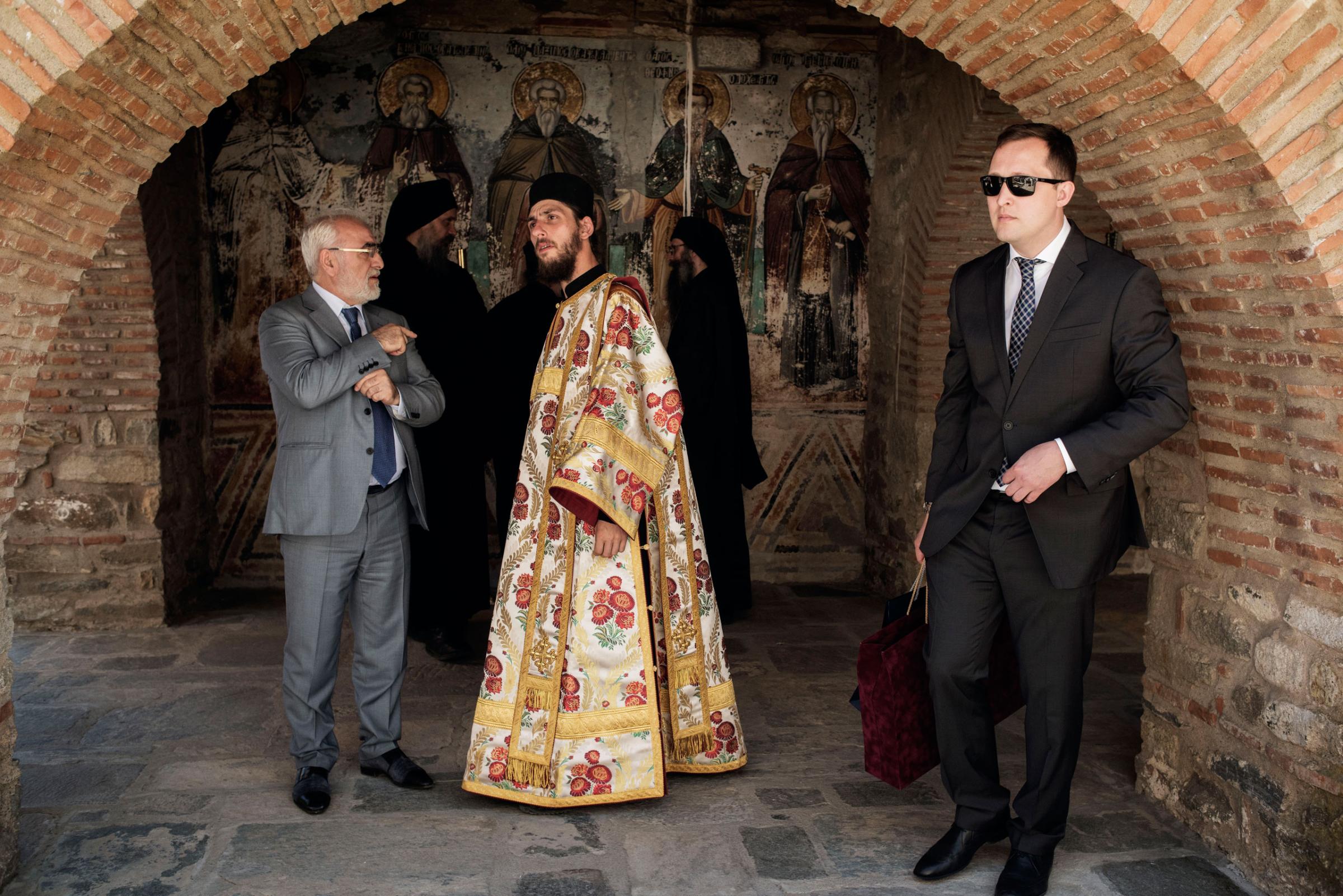 Monks and laymen stand outside the Protaton, the oldest church on Mount Athos, a self-governing monastic community in northern Greece, May 28, 2016.