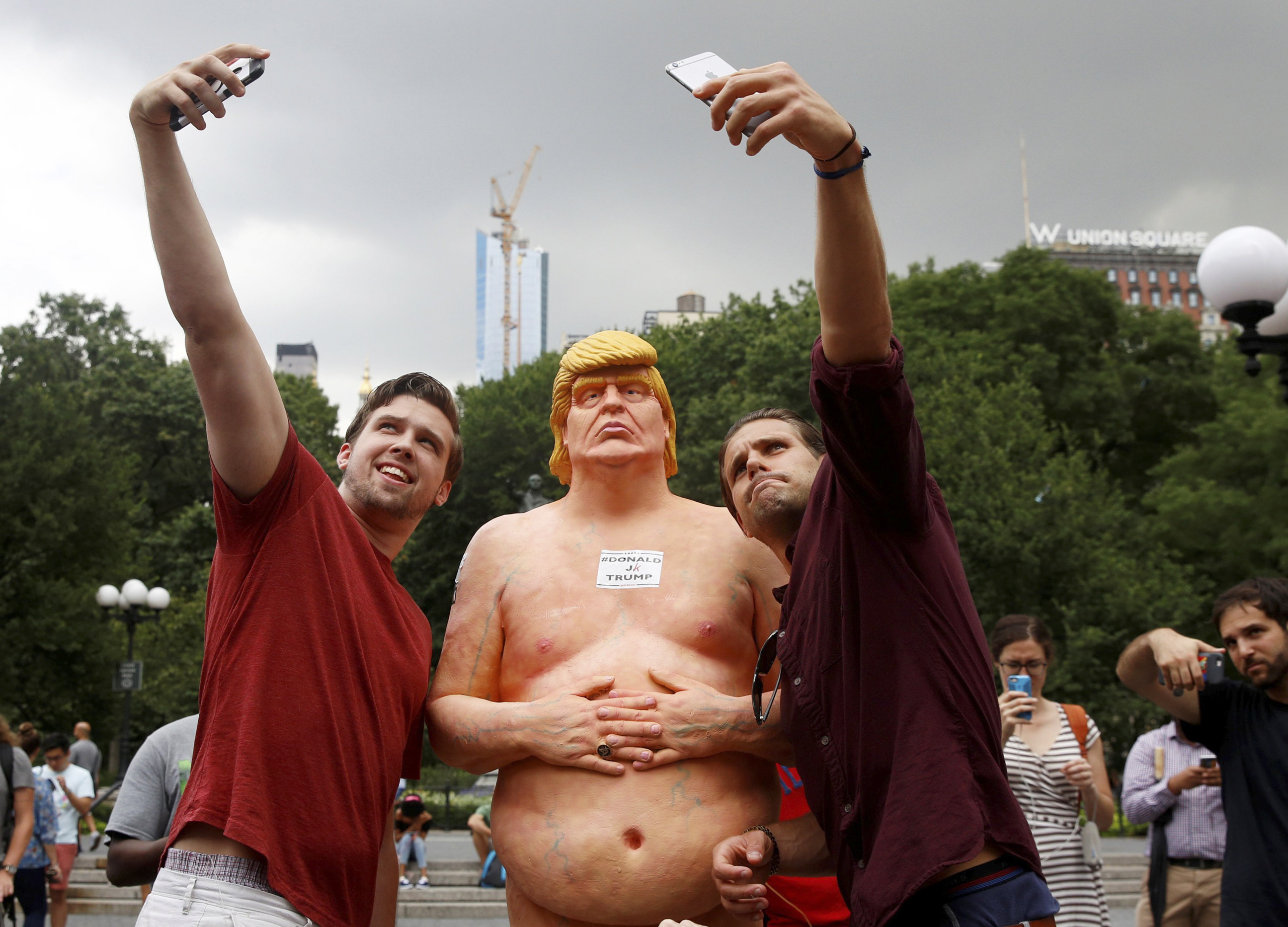 People pose for selfies with a naked statue of U.S. Republican presidential nominee Donald Trump that was left in Union Square Park in New York City on Aug. 18, 2016. (Brendan McDermid—Reuters)