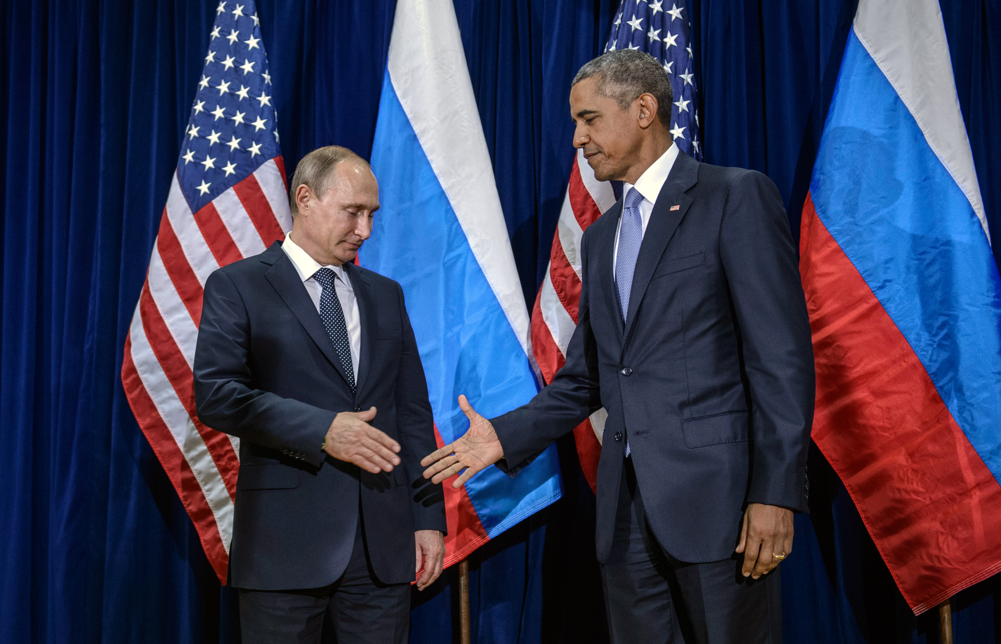 Russian President Vladimir Putin (L) and U.S. President Barack Obama shake hands for the cameras before the start of a bilateral meeting at the United Nations headquarters in New York City on Sept. 28, 2015.