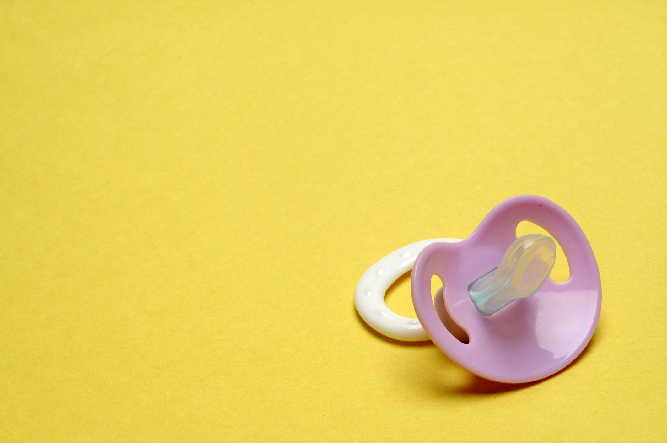 Dummy Pacifier on Yellow Background with Copy Space (Getty Images)