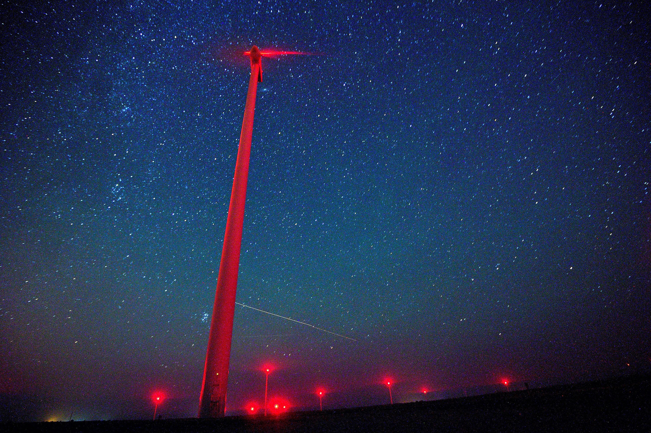 A view of meteors lighting up the night sky above a wind turbine at 'Saint Nikola' wind park near the Kavarna, some 500km from Sofia, Bulgaria, Aug. 12, 2016.