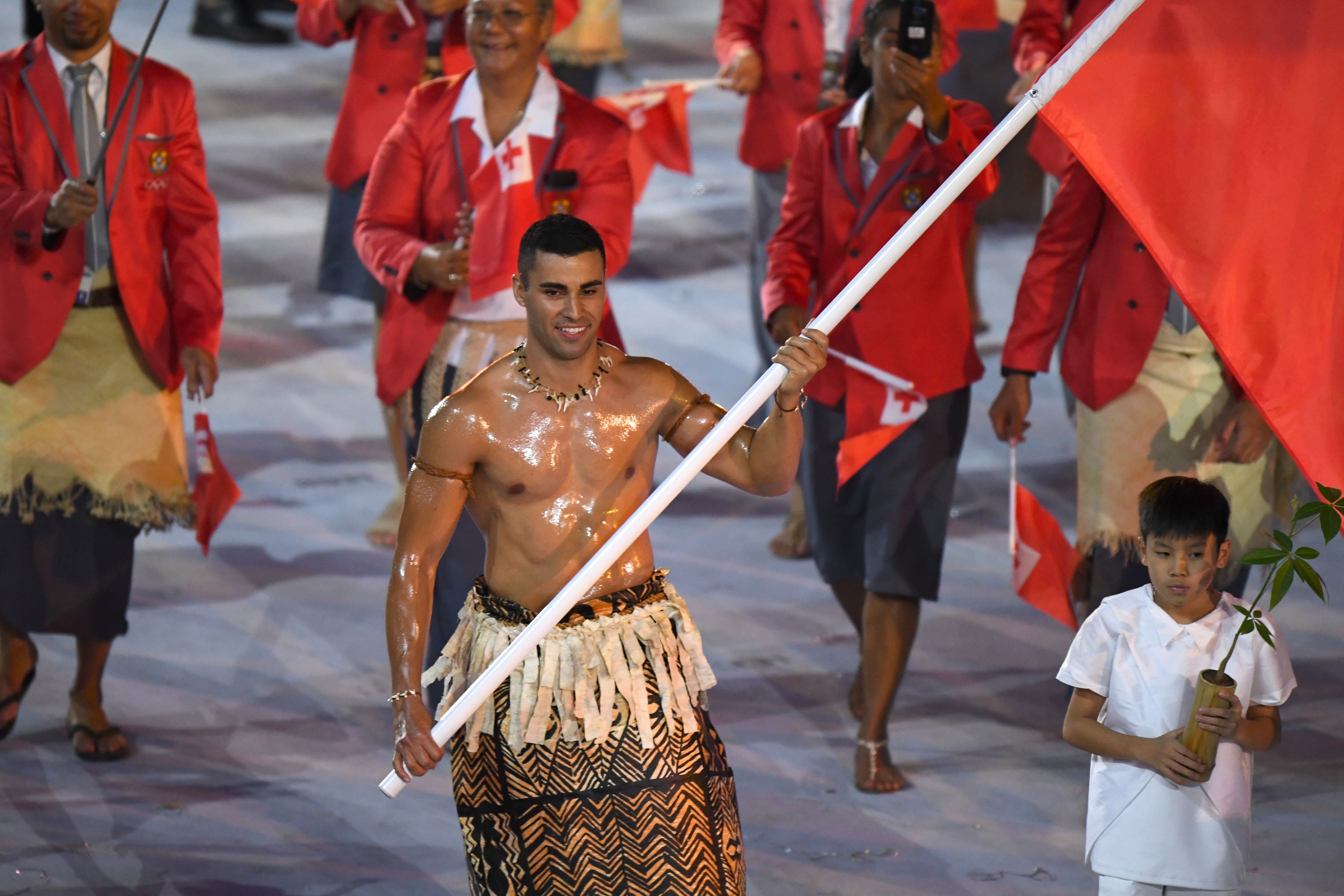 Tonga's flagbearer Pita Nikolas Taufatofua leads his delegation during the opening ceremony of the Rio 2016 Olympic Games at the Maracana stadium in Rio de Janeiro on Aug. 5, 2016. (Olivier Mornin—AFP/Getty Images)