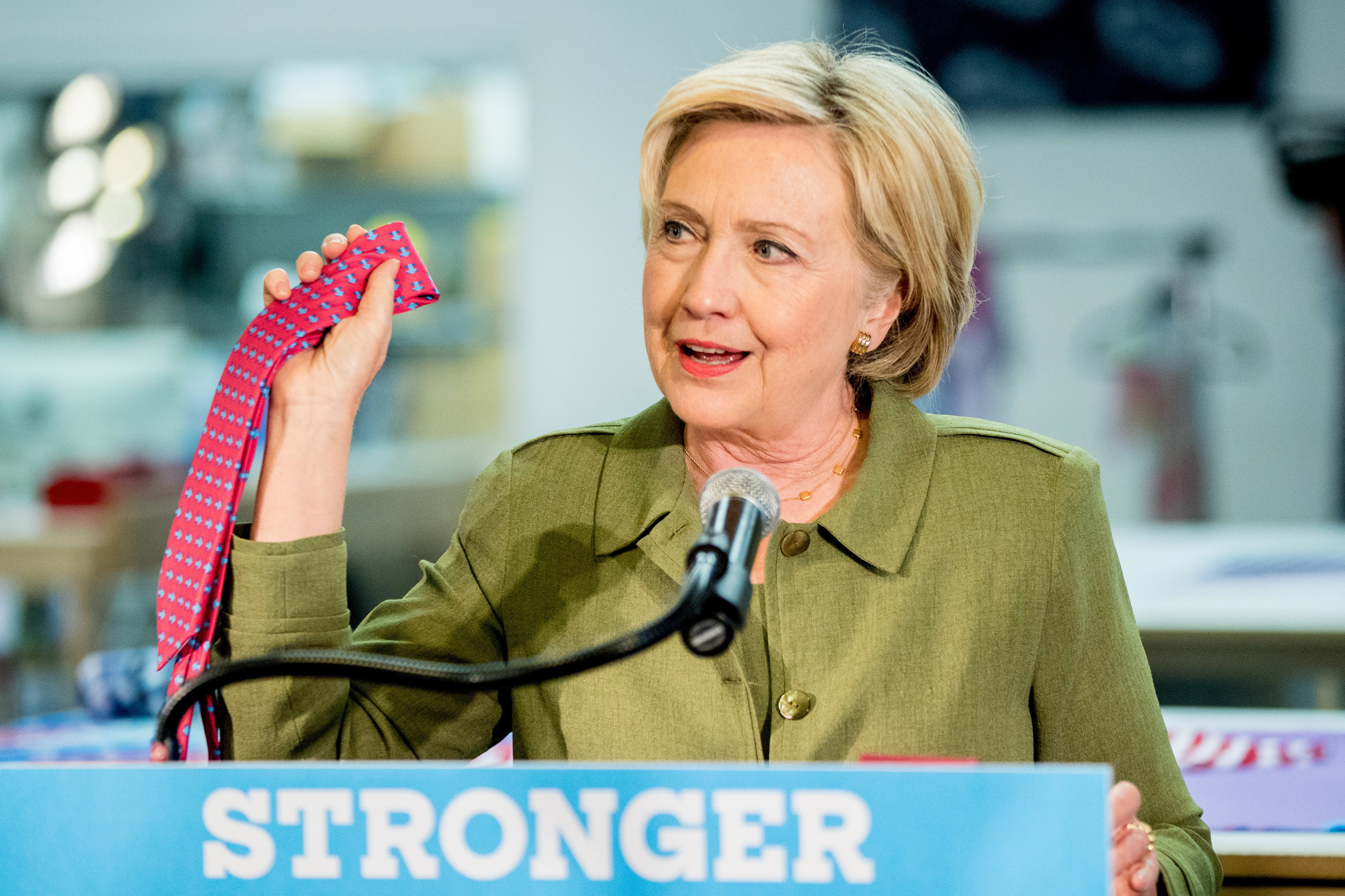 Democratic presidential candidate Hillary Clinton holds up an American made Knotty Tie as she speaks after taking a tour of Knotty Tie Company in Denver on Aug. 3, 2016.