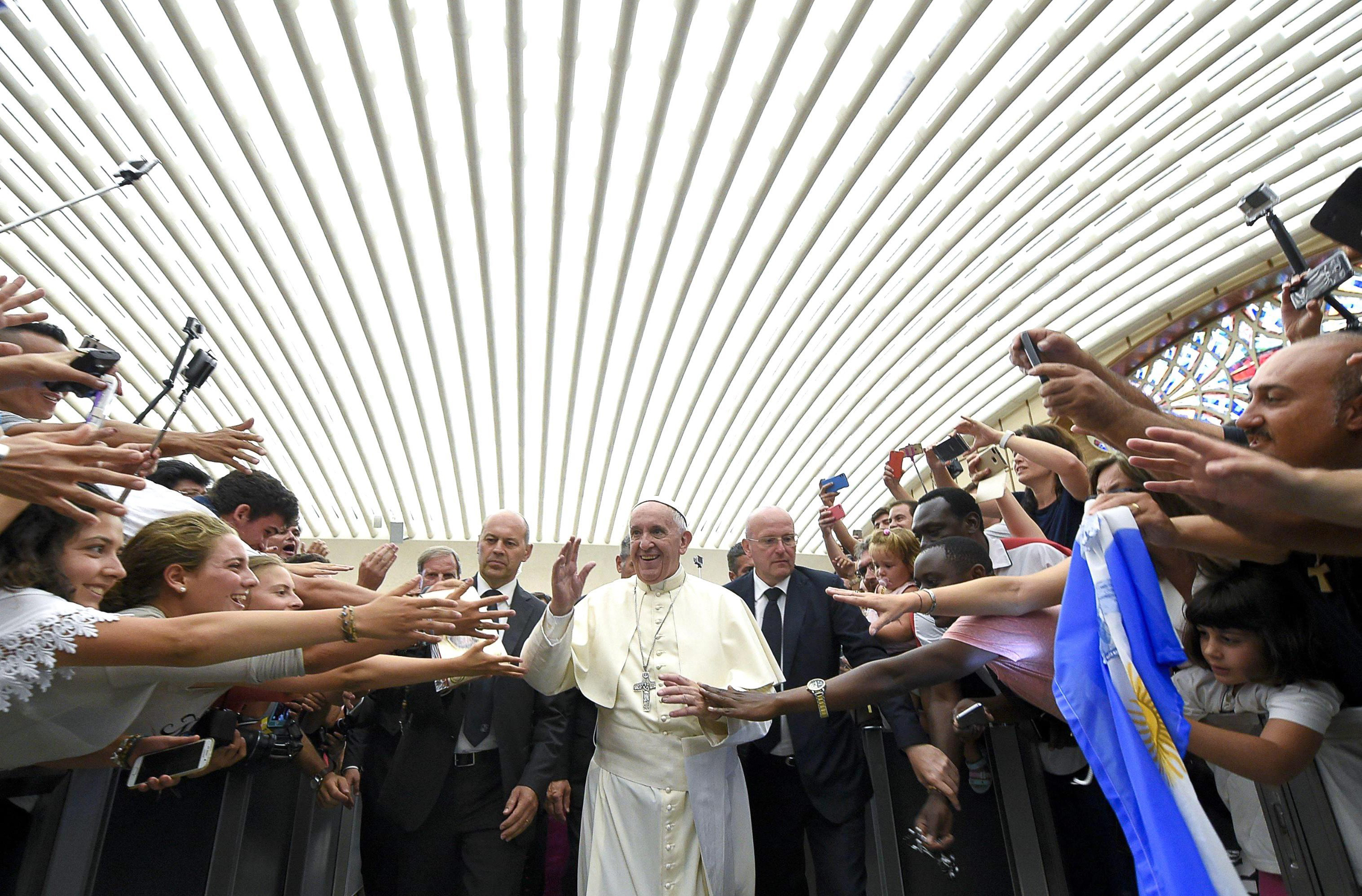 Pope Francis greeting faithful during his weekly general audience, in the Paul VI Hall, Vatican City, on Aug. 03, 2016. (L'osservatore Romano Press Office/EPA)