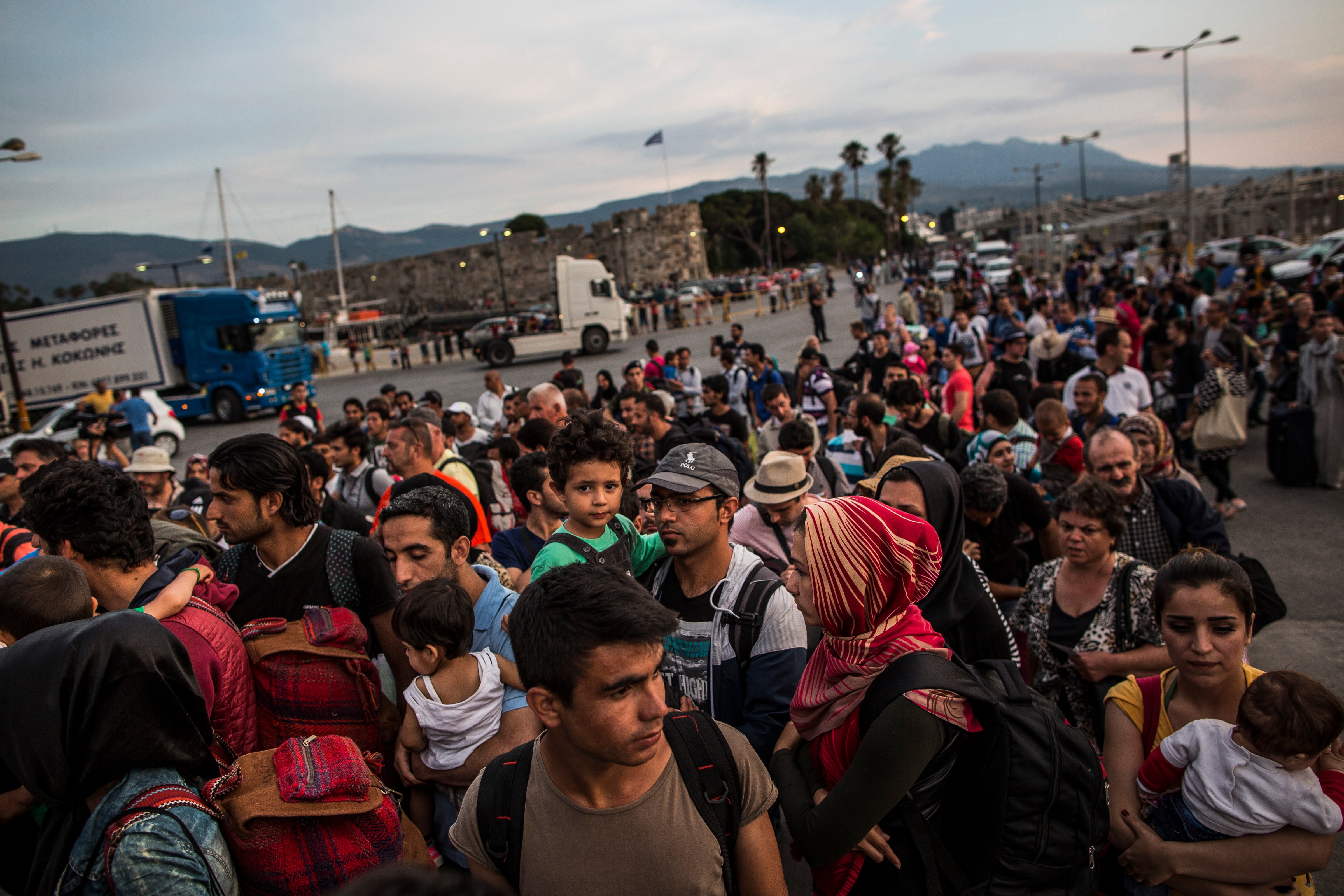 Hundreds of migrant men, women and children along with tourists and locals board a ferry bound for Athens on June 04, 2015 in Kos, Greece.