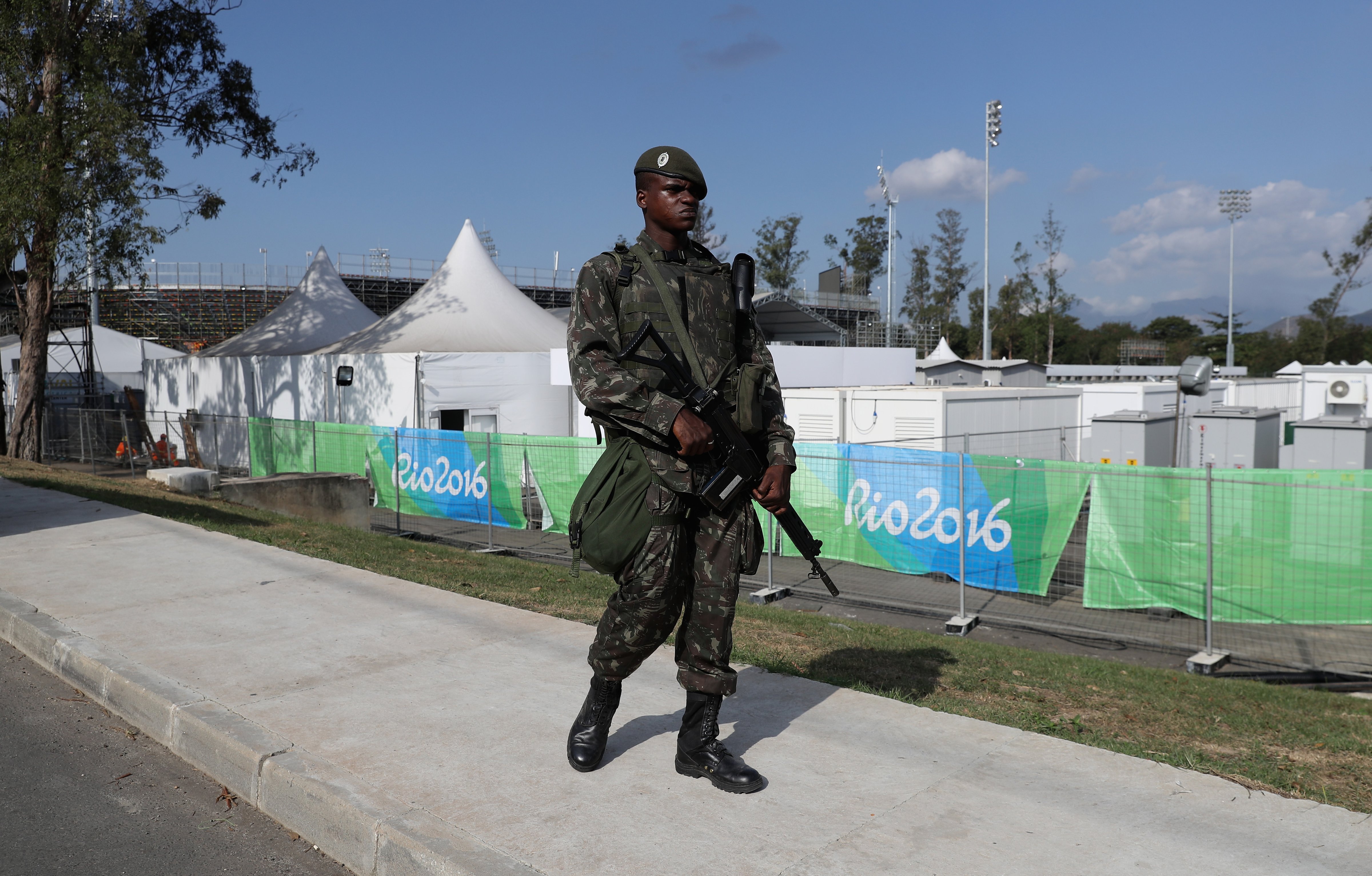 A soldier patrols the perimeter fence around the Deodora Olympic sports complex during the build up to the Rio Olympic Games on July 30, 2016 in Rio de Janeiro. (David Rogers—Getty Images)