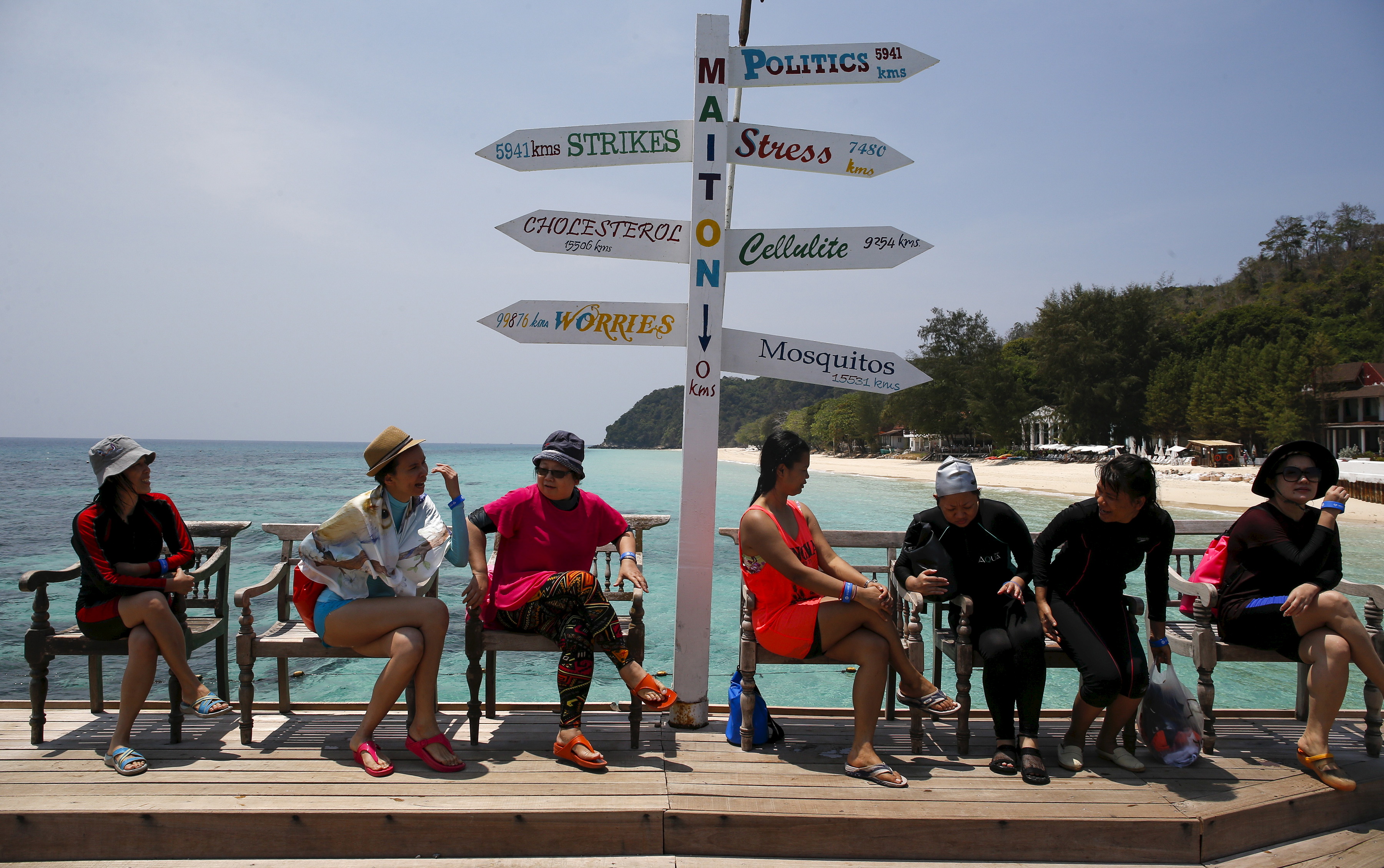 Tourists sit as they wait for their boat at Maiton Island in Phuket, Thailand, on March 18, 2016 (Athit Perawongmetha—Reuters)