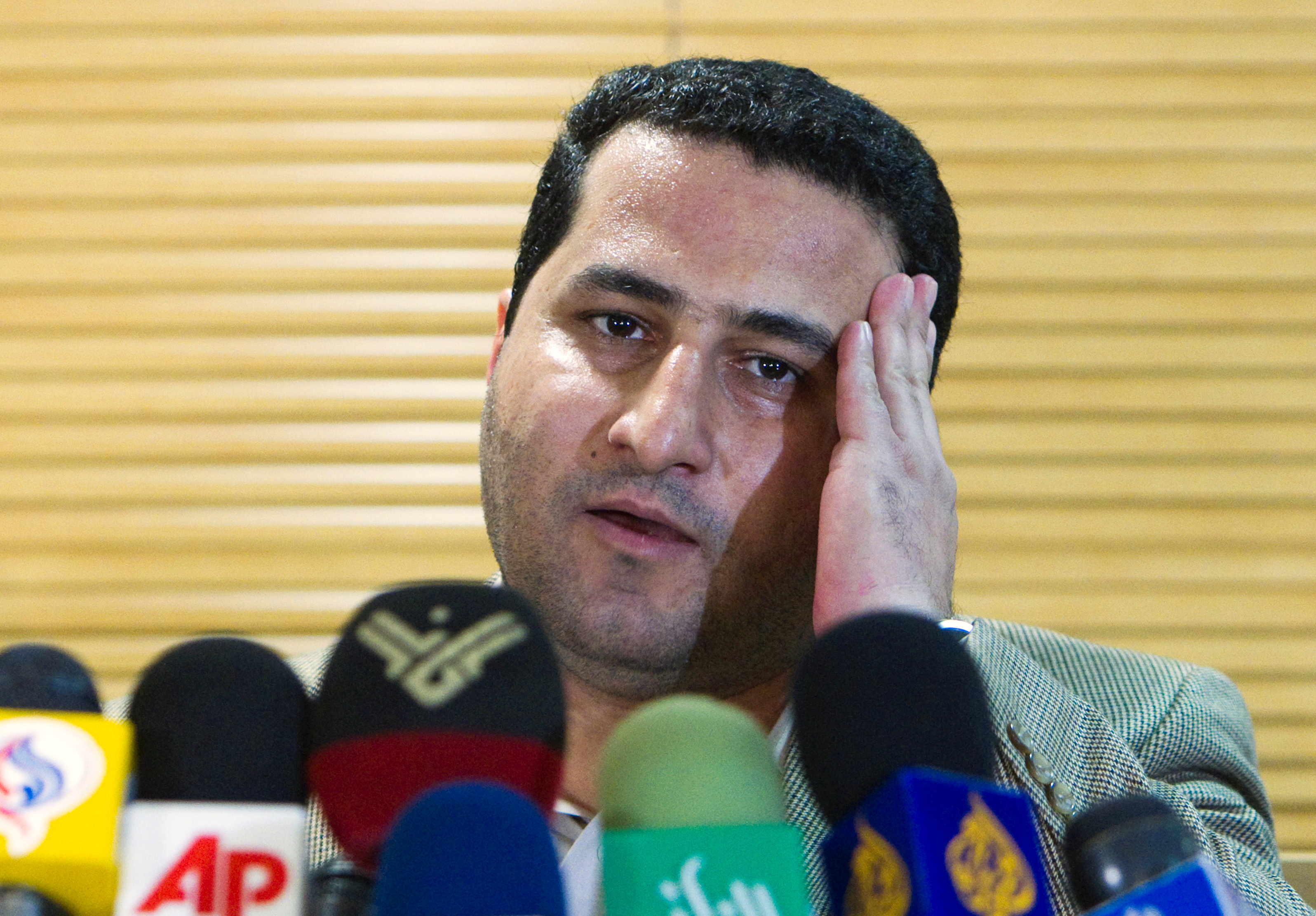 Iranian scientist Shahram Amiri speaks to journalists as he arrives at the Imam Khomini Airport in Tehran