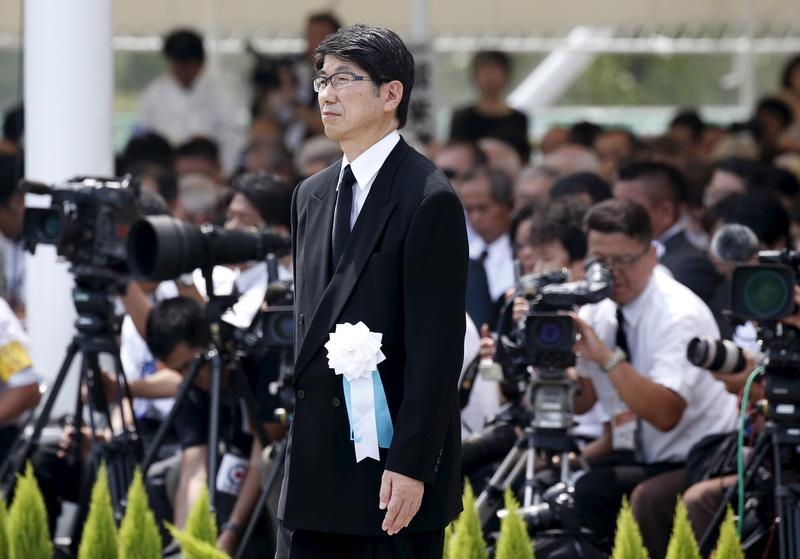Nagasaki Mayor Tomihisa Taue walks to deliver his speech during a ceremony commemorating the 70th anniversary of the 1945 atomic bombing of the city at Nagasaki's Peace Park in Nagasaki