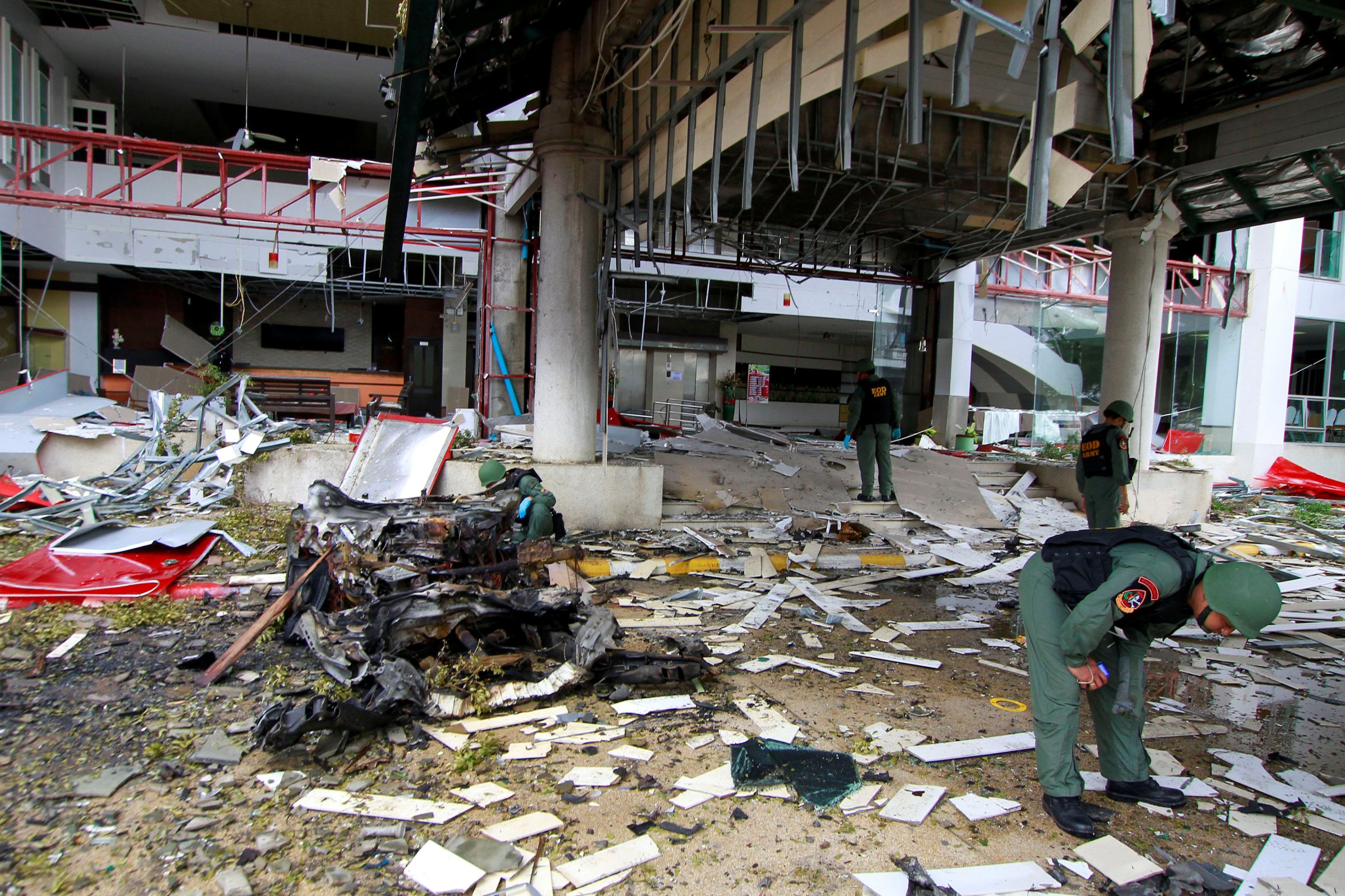 Thai soldiers inspect the scene of a car bomb blast outside a hotel in the southern province of Pattani