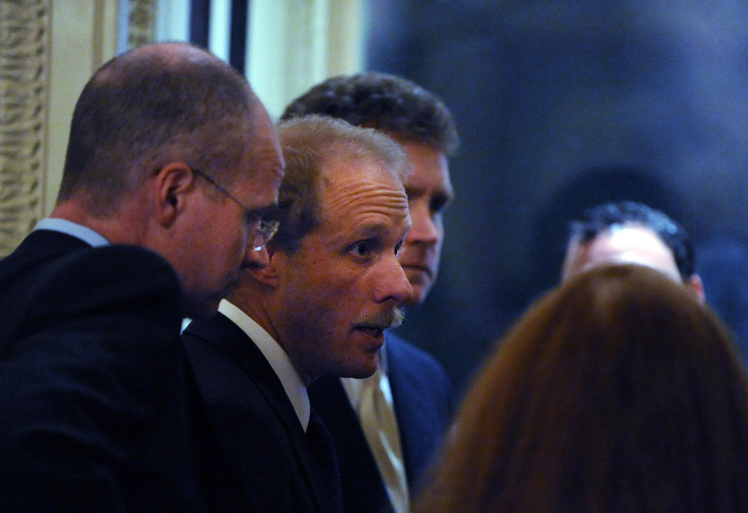 Stephen Feinberg (second from left), a participant in the auto bailout deal, convenes with his crew as lawmakers discuss the auto bailout bill at the US Capitol in Washington on Dec. 11, 2008.