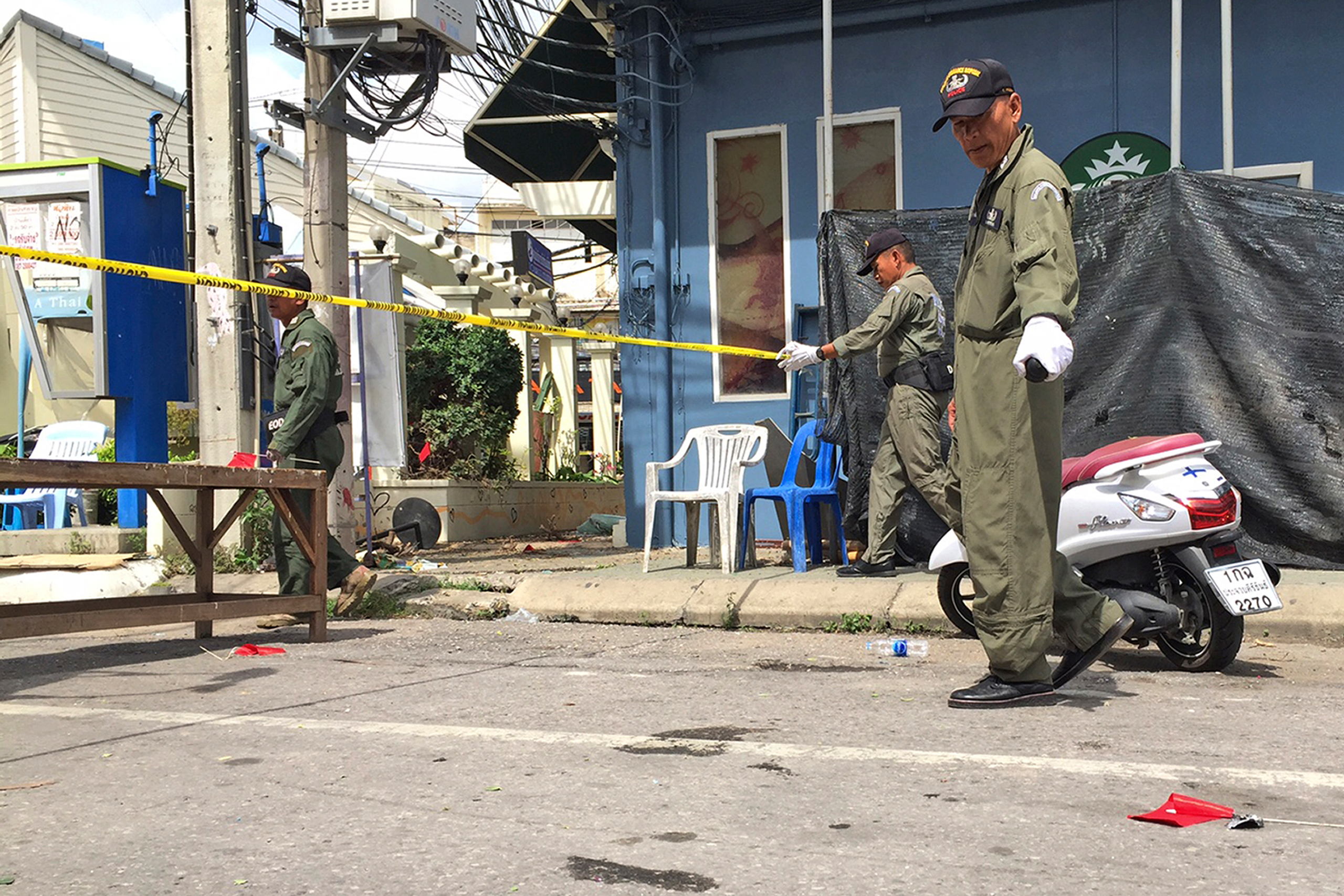 Investigators work at the scene of an explosion in the resort town of Hua Hin, 150 miles south of Bangkok, on Aug. 12, 2016. (Jerry Harmer—AP)