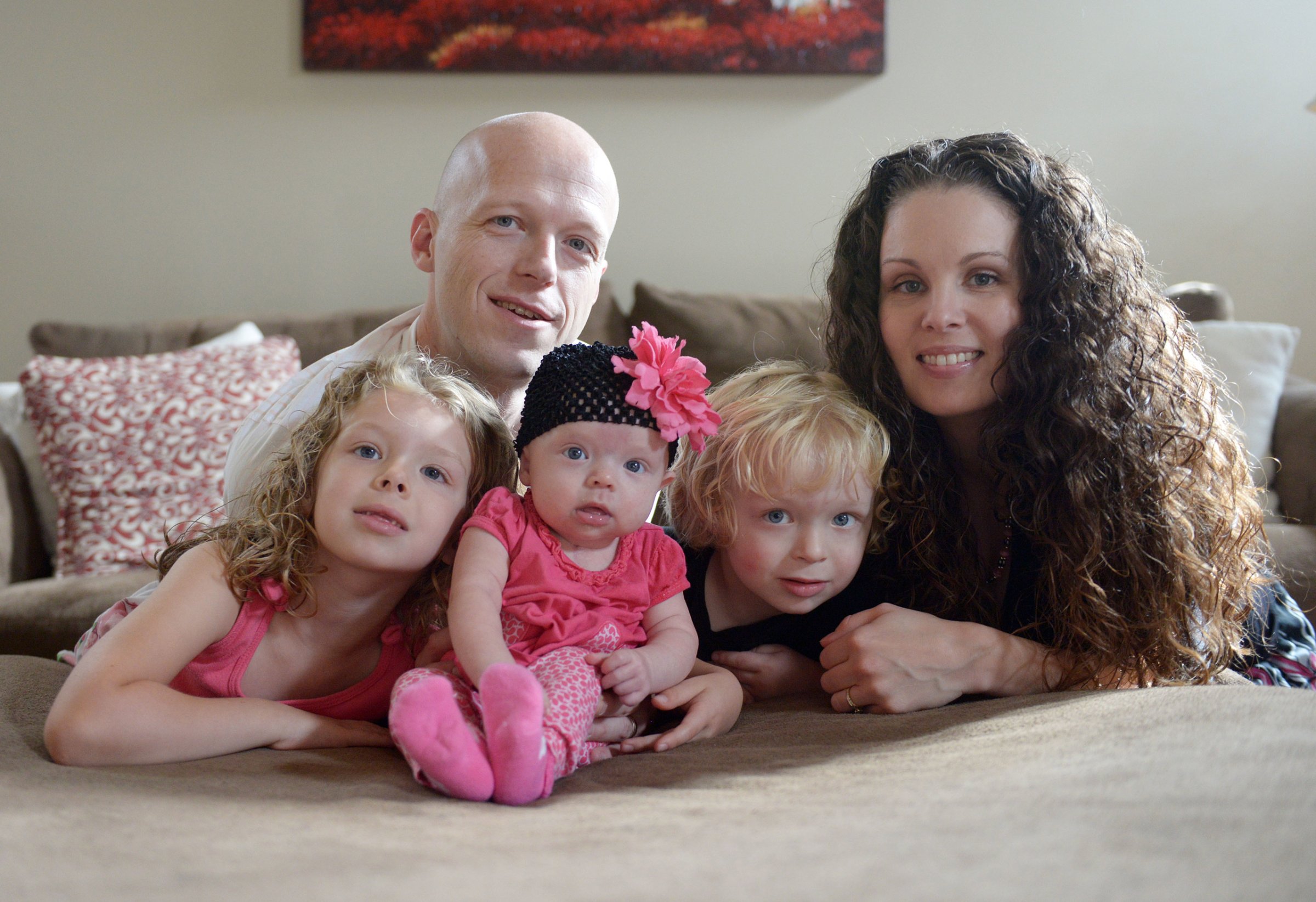 In this Sept. 1, 2014, photo, Willow Short, 4-month-old, center, along with her parents Megan and Mark and sister Liana, 6, and brother Mark, 3, poses for a photo in Sinking Spring, Pa. Willow Short had a heart transplant at 6-days-old. The couple featured in news stories about their difficulties getting medication for the daughter who had a heart transplant were found shot to death in their home along with their three children in apparent murder-suicide, authorities said Sunday, Aug. 7, 2016. (Susan L. Angstadt/Reading Eagle via AP)