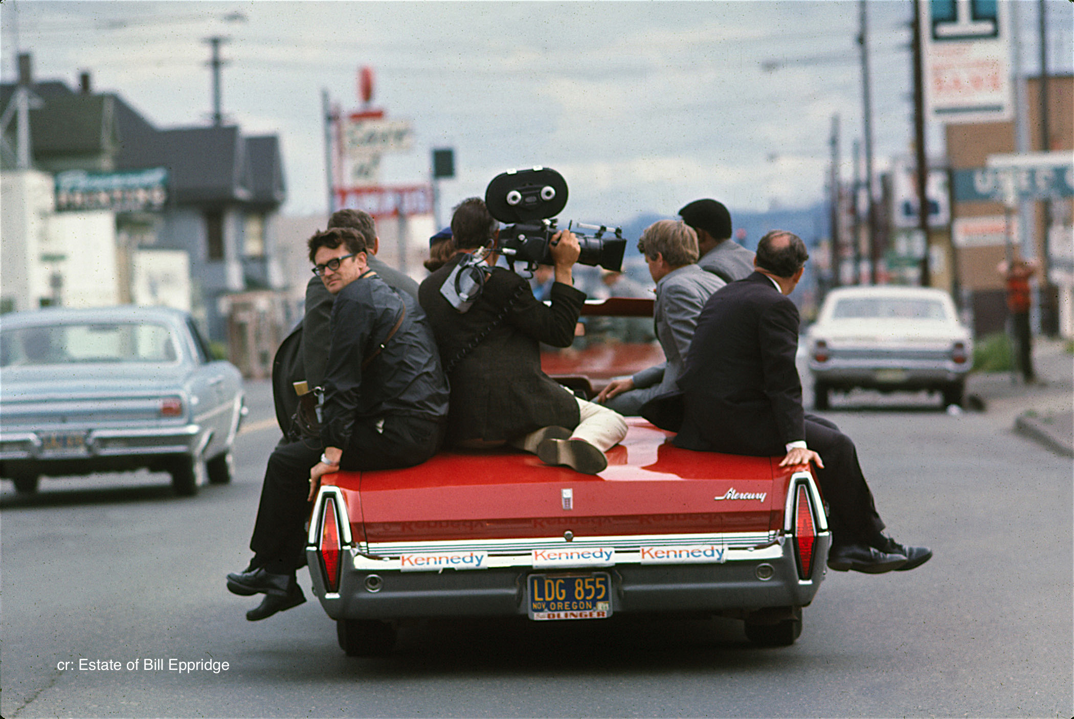 Senator Robert F. Kennedy riding with the press on the back of a convertible, Oregon, April or May 1968.