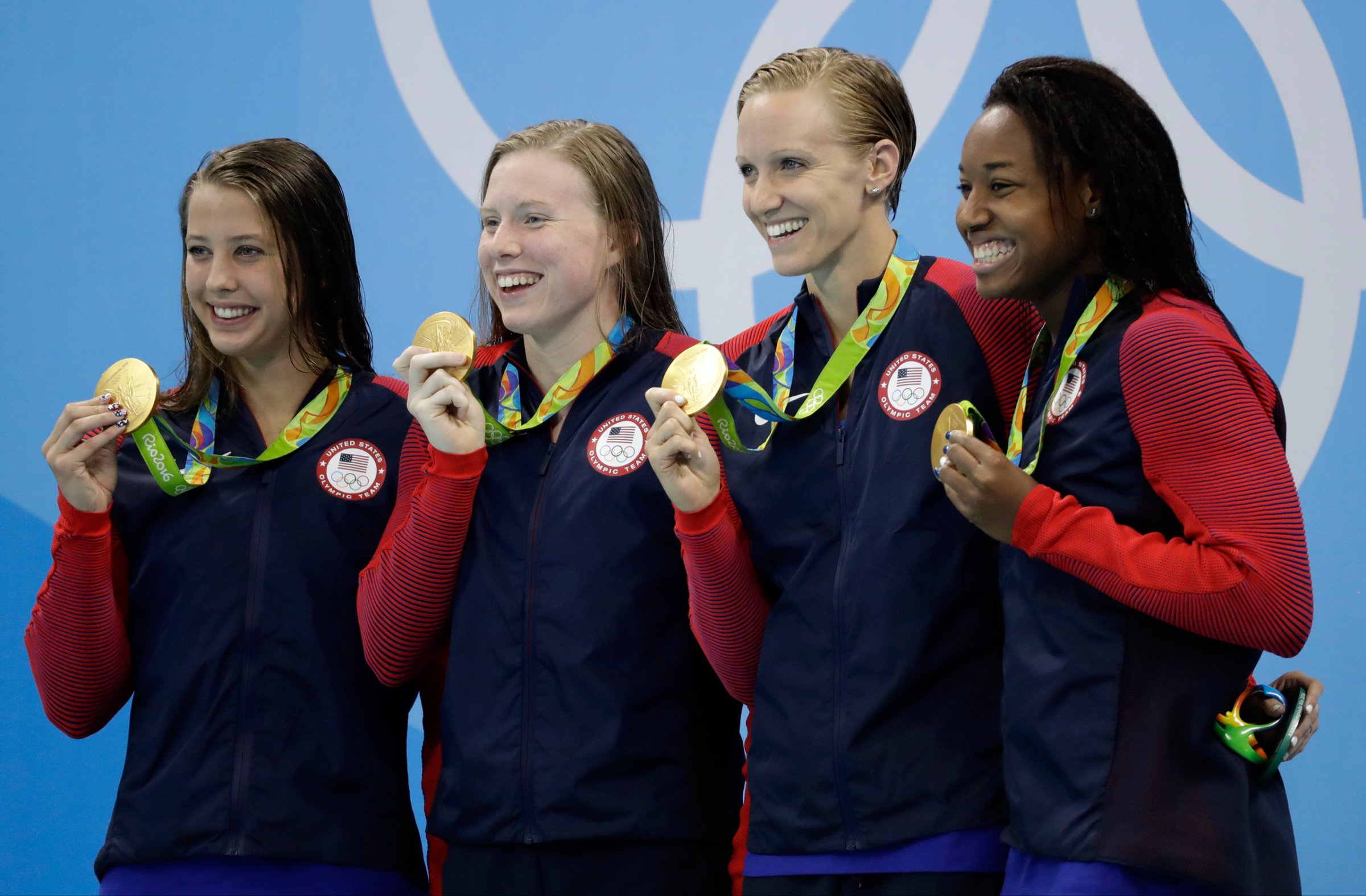 From left to right, United States' Kathleen Baker, Lilly King, Dana Vollmer and Simone Manuel display their gold medals for the women's 4 x 100-meter medley relay final during the swimming competitions at the 2016 Summer Olympics, Saturday, Aug. 13, 2016, in Rio de Janeiro, Brazil. (AP Photo/Rebecca Blackwell)