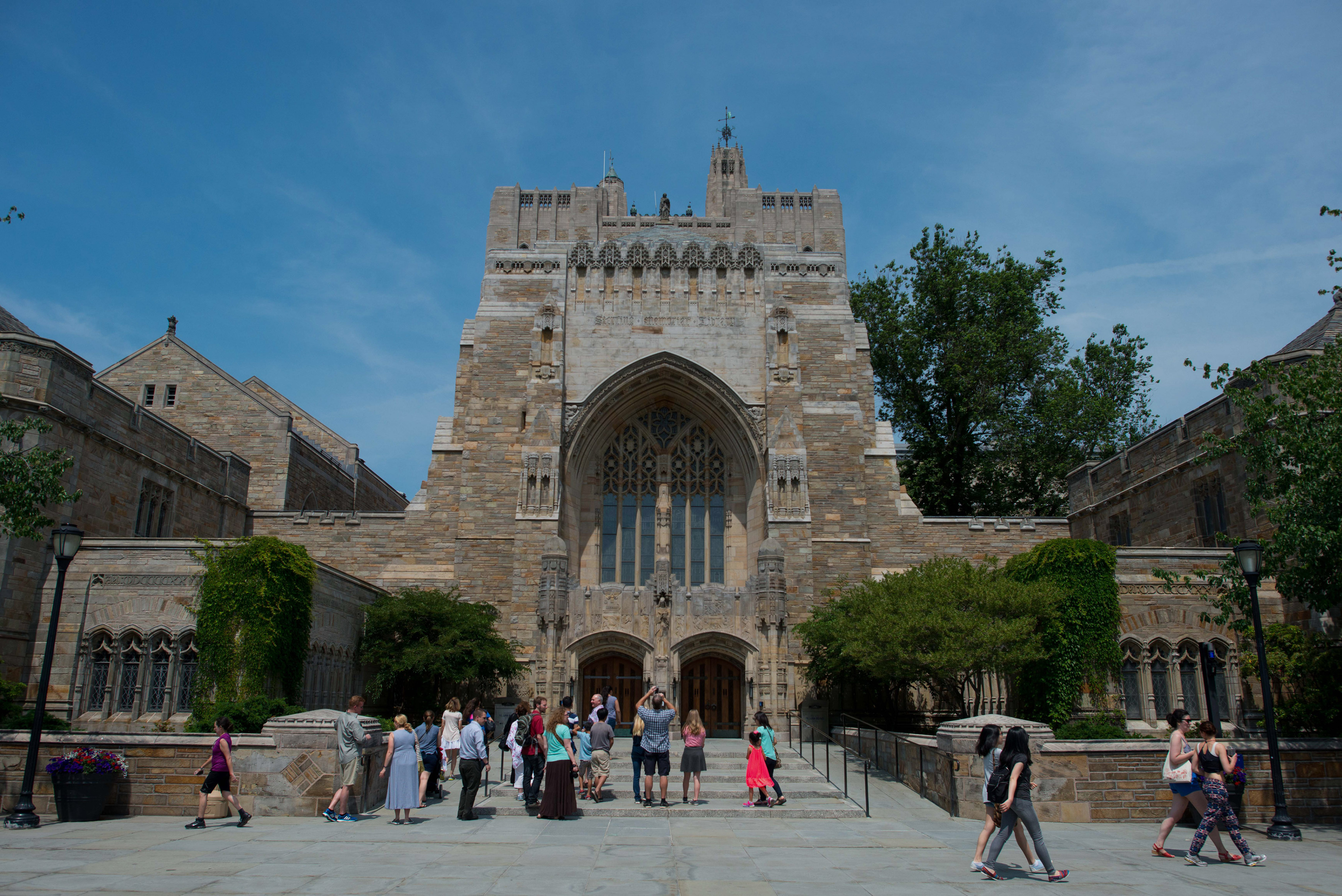 A tour group makes a stop at the Sterling Memorial Library on the Yale University campus in New Haven, Conn., on June 12, 2015. (Bloomberg via Getty Images)