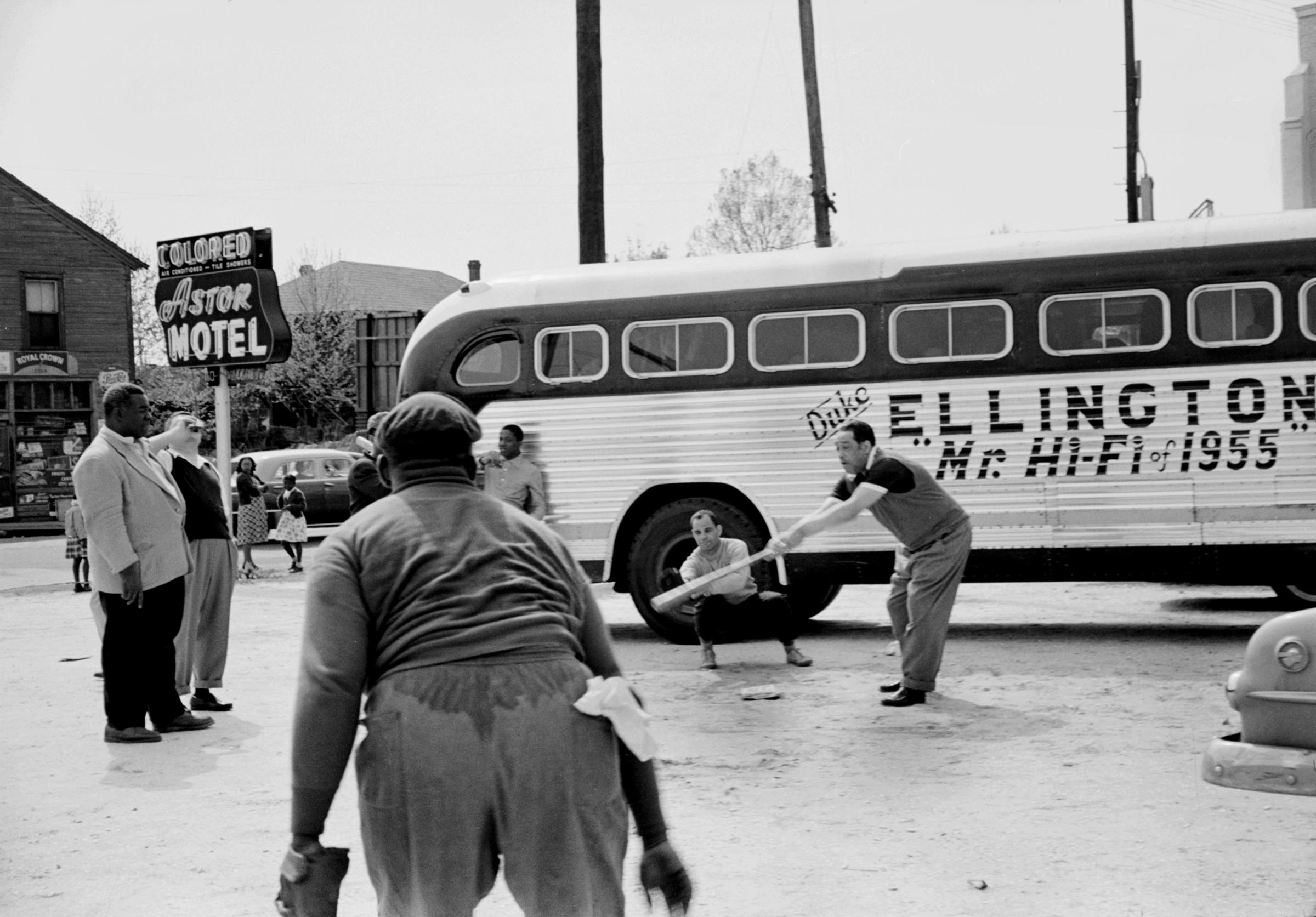 Duke Ellington playing baseball in segregated hotel parking lot.