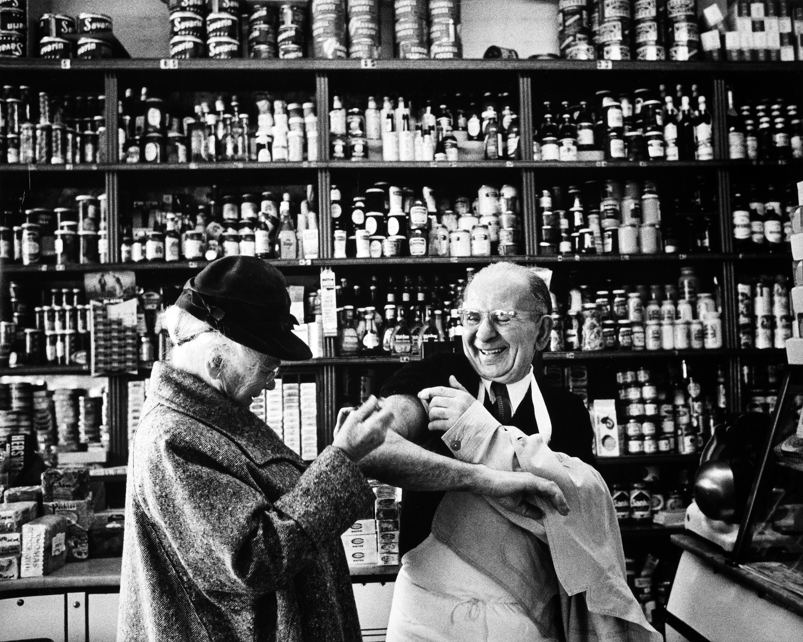 Dr. Connie M. Guion, the first female doctor in the United States to be named Professor of Clinical Medicine at Cornell University's Weill Medical College visits her neighborhood grocer to give him a vitamin shot, 1958. Published in  The Amazing Doctor Guion,  LOOK 25: 19 (Sept. 12, 1961)
