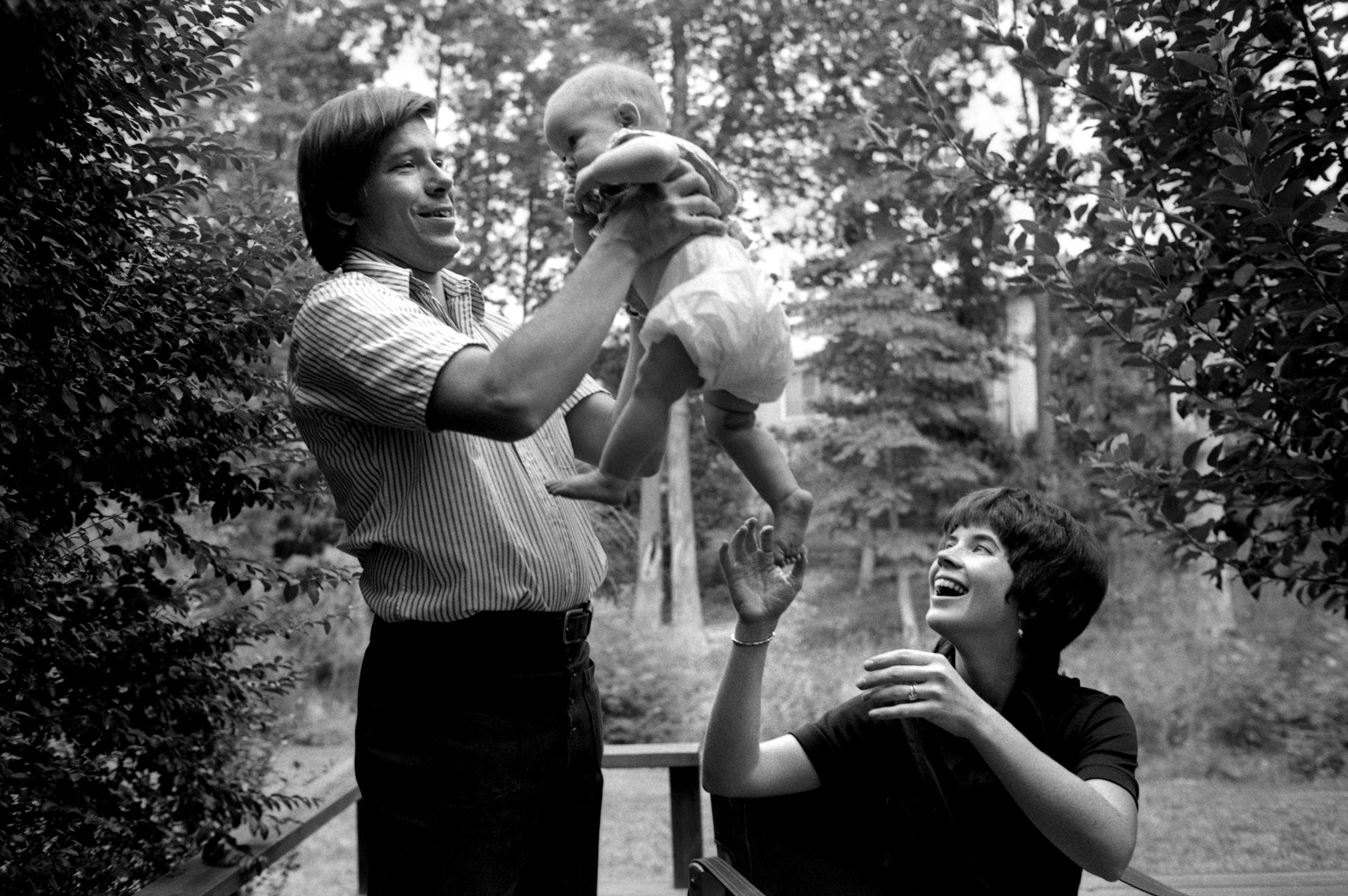 Ted and Sally Oldham playing with their daughter.