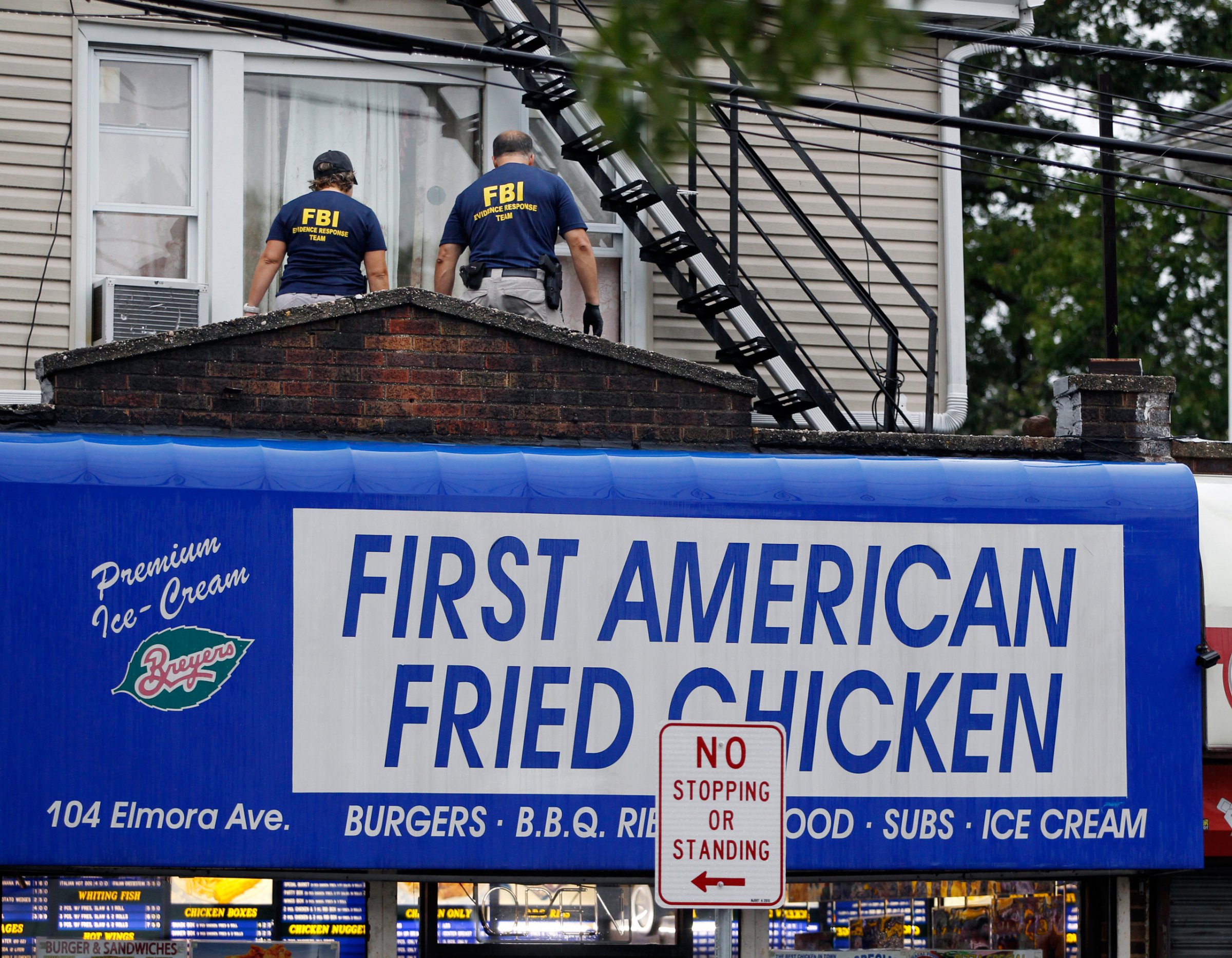 FBI agents walk around the roof outside an apartment during an investigation at a building Monday, Sept. 19, 2016, in Elizabeth, N.J. FBI agents are searching the apartment that is tied to Ahmad Khan Rahami wanted for questioning in the New York City bombing. (AP Photo/Mel Evans)