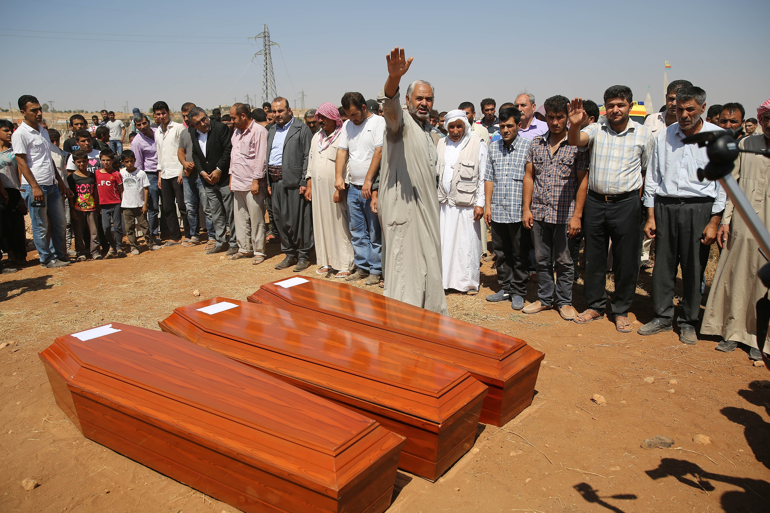 Relatives hold funeral of Syrian children Alan, 2, his brother Galip, 3, and husband of Zahin Kurdi, 27, who drowned after their boat sank en route to the Greek islands in the Aegean Sea, in the Syrian border town of Kobani (Ayn al-Arab) on Sept. 4, 2015. (Isa Terli—Anadolu Agency/Getty Images)
