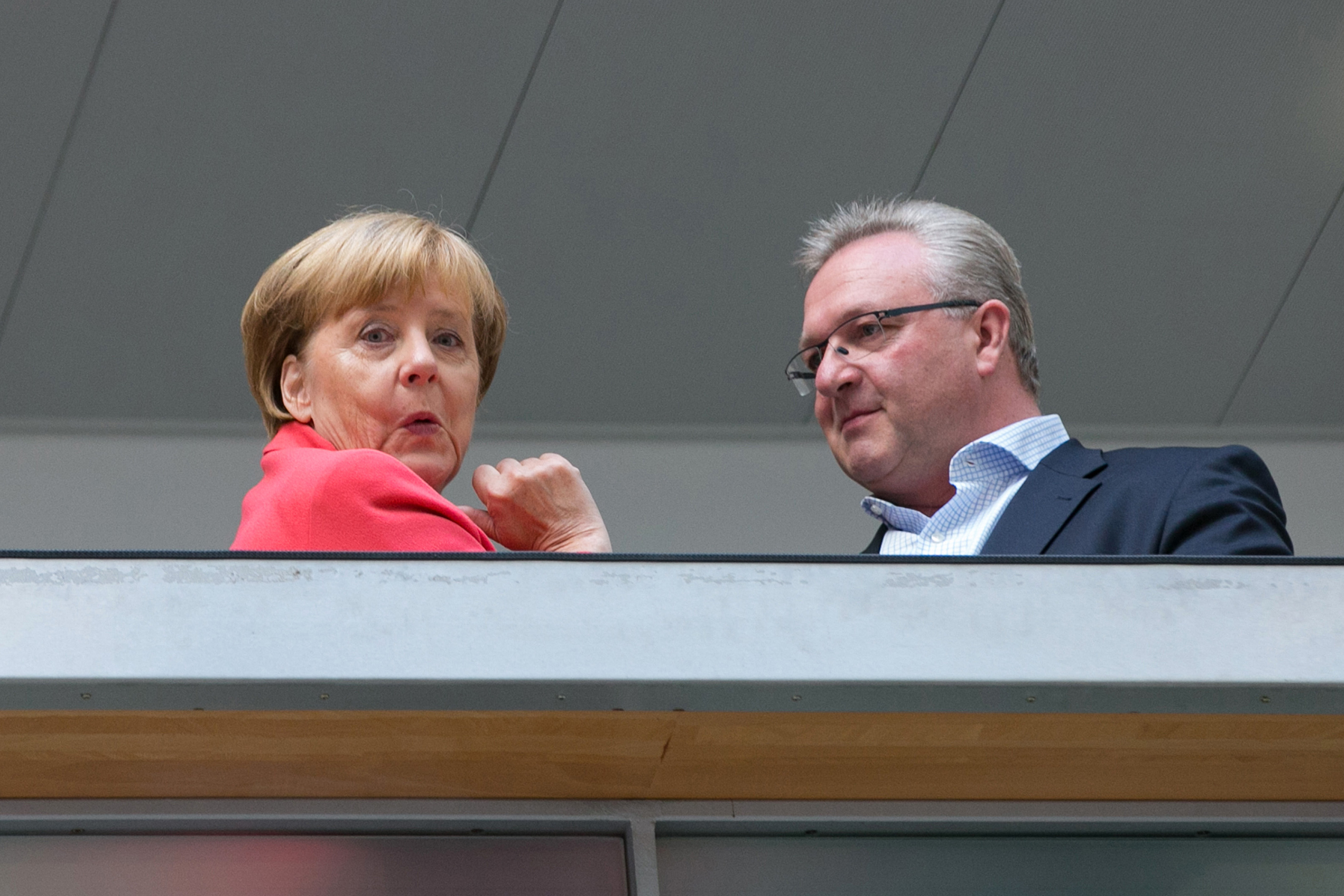 Angela Merkel, Germany's chancellor and Christian Democratic Union (CDU) party leader, left, reacts as she stands with Frank Henkel, the CDU candidate in Berlin, ahead of a CDU federal board meeting at the party's headquarters in Berlin, Germany, on Monday, Sept. 19, 2016.