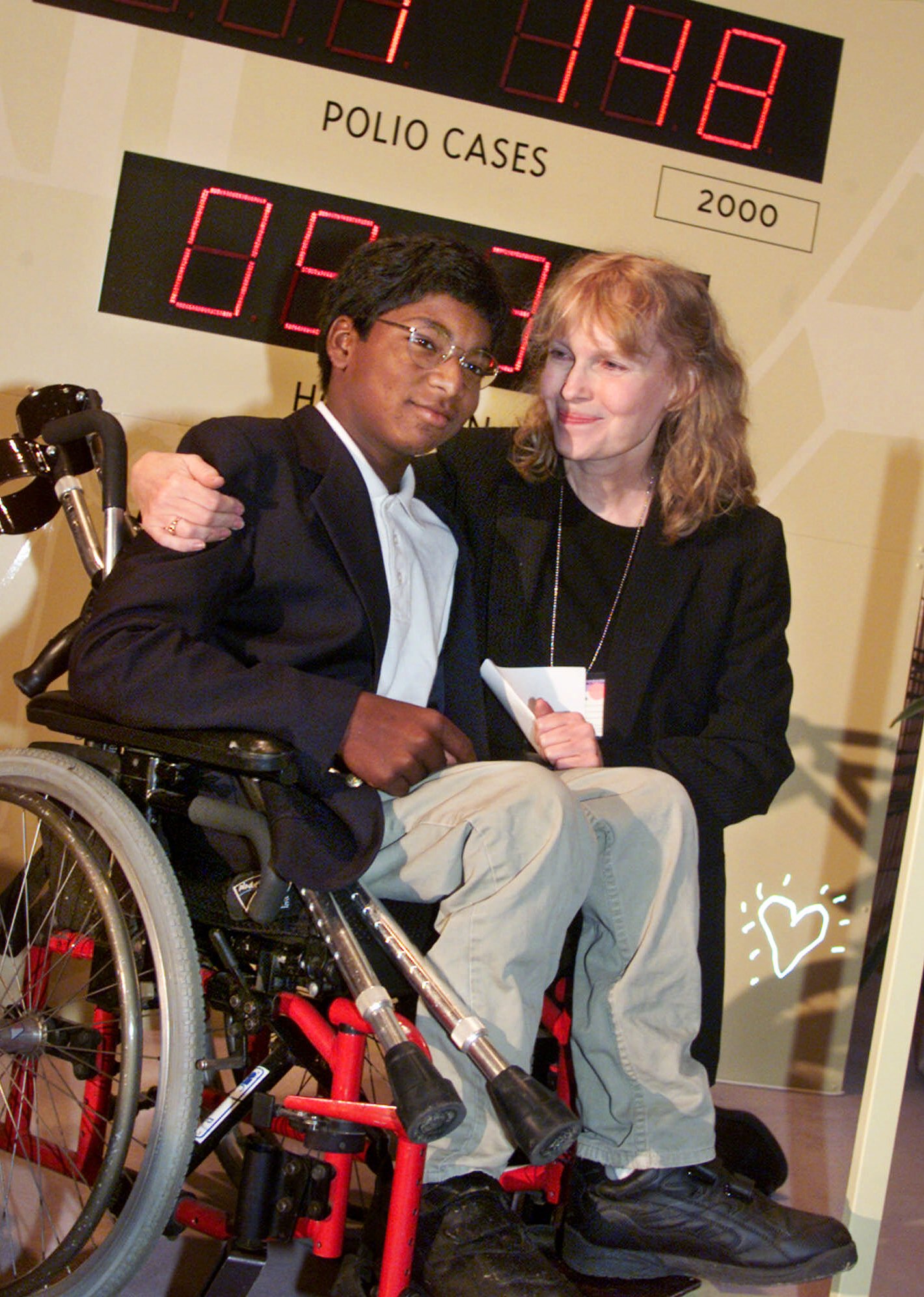 Actress Mia Farrow and her adopted son Thaddeus as they participate in the global summit on polio eradication, Sept. 27, 2000, at United Nations headquarters. (Richard Drew—AP)