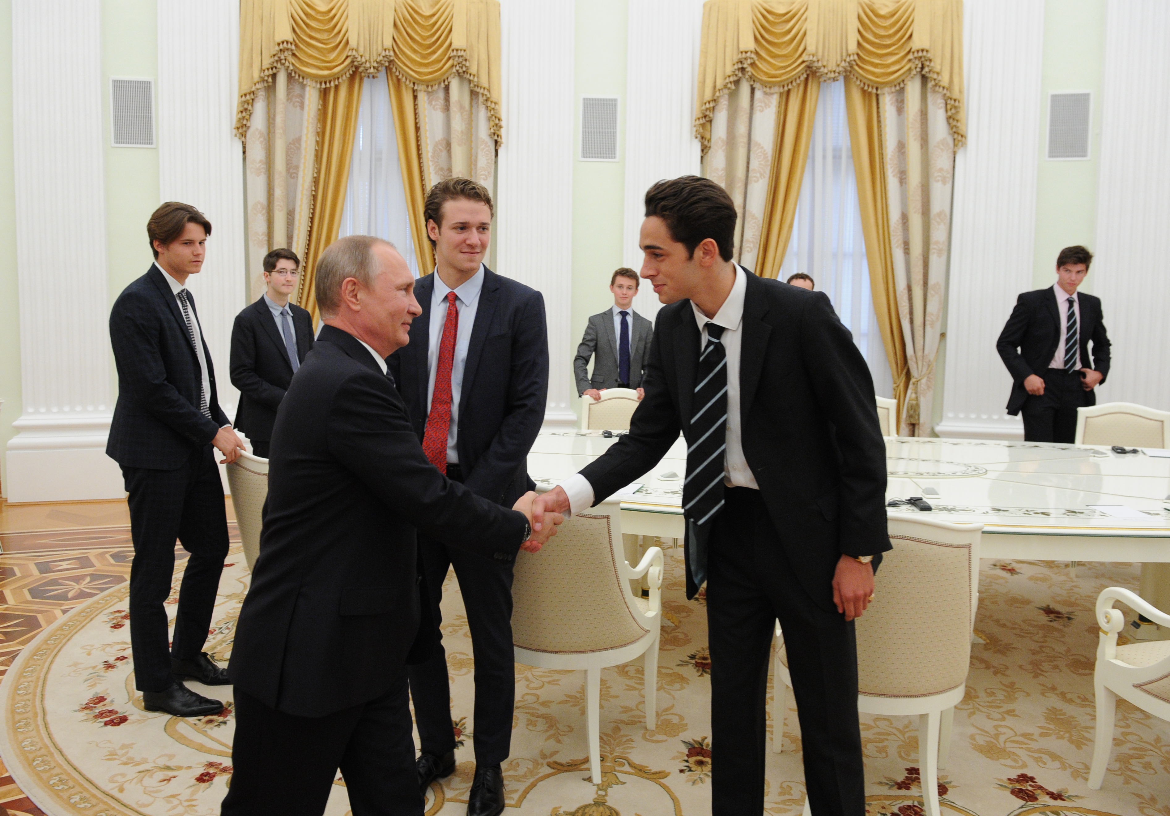 Russian President Vladimir Putin, foreground, left, meets with students at Eton College in the Kremlin. (Michael Klimentyev—Sputnik/AP)