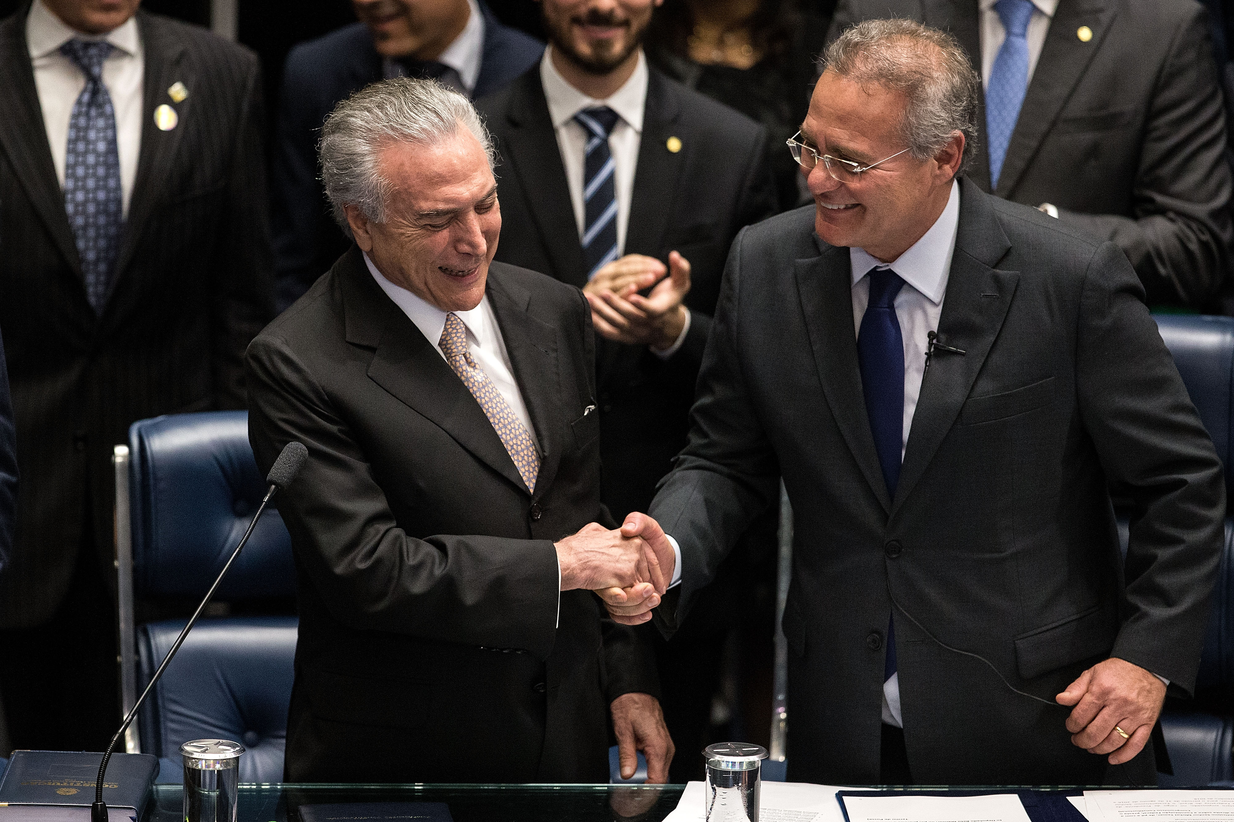 Michel Temer (L) shakes hands with Brazilian Senate President Renan Calheiros during his swear-in ceremony as President of Brazil in Brasilia, Brazil, Aug. 31, 2016. (Xinhua—Xinhua/Sipa USA)