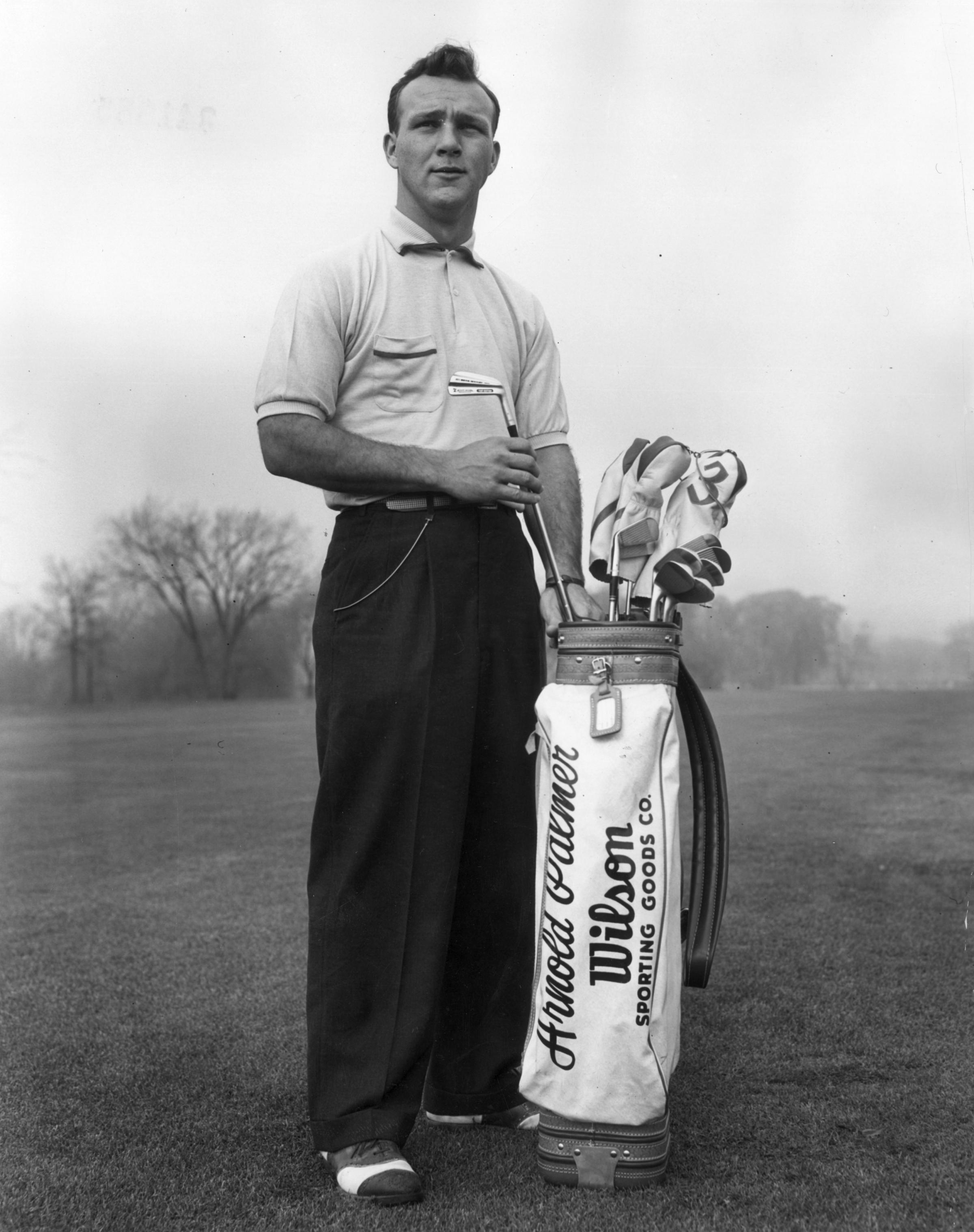 A portrait of American golfer Arnold Palmer pulling a driving iron from a golf bag on a golf course circa 1953. Palmer died Sunday in Pittsburgh. He was 87.