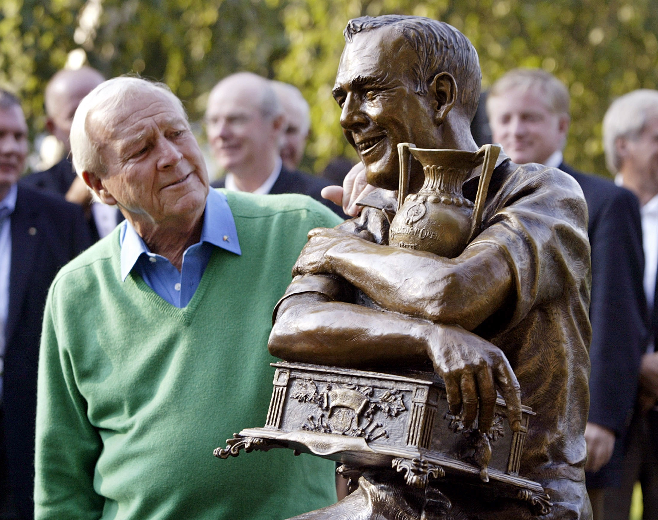Golfer Palmer looks at a statue of himself commemorating the 50th anniversary of his first PGA tour ...