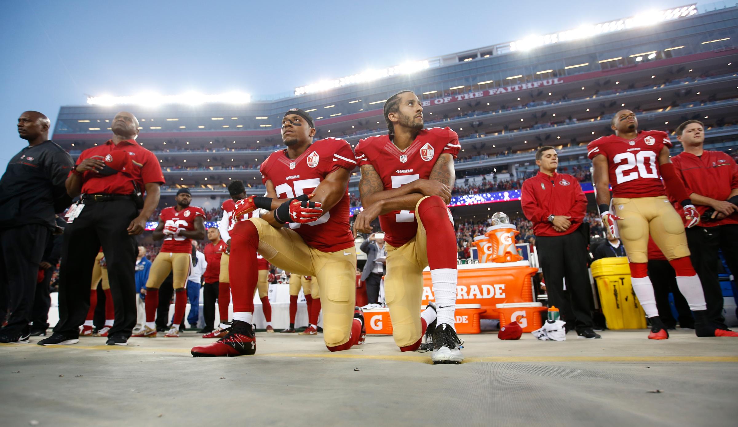 Eric Reid #35 and Colin Kaepernick #7 of the San Francisco 49ers kneel during the anthem, prior to the game against the Los Angeles Rams at Levi Stadium in Santa Clara, Calif., on Sept. 12, 2016.