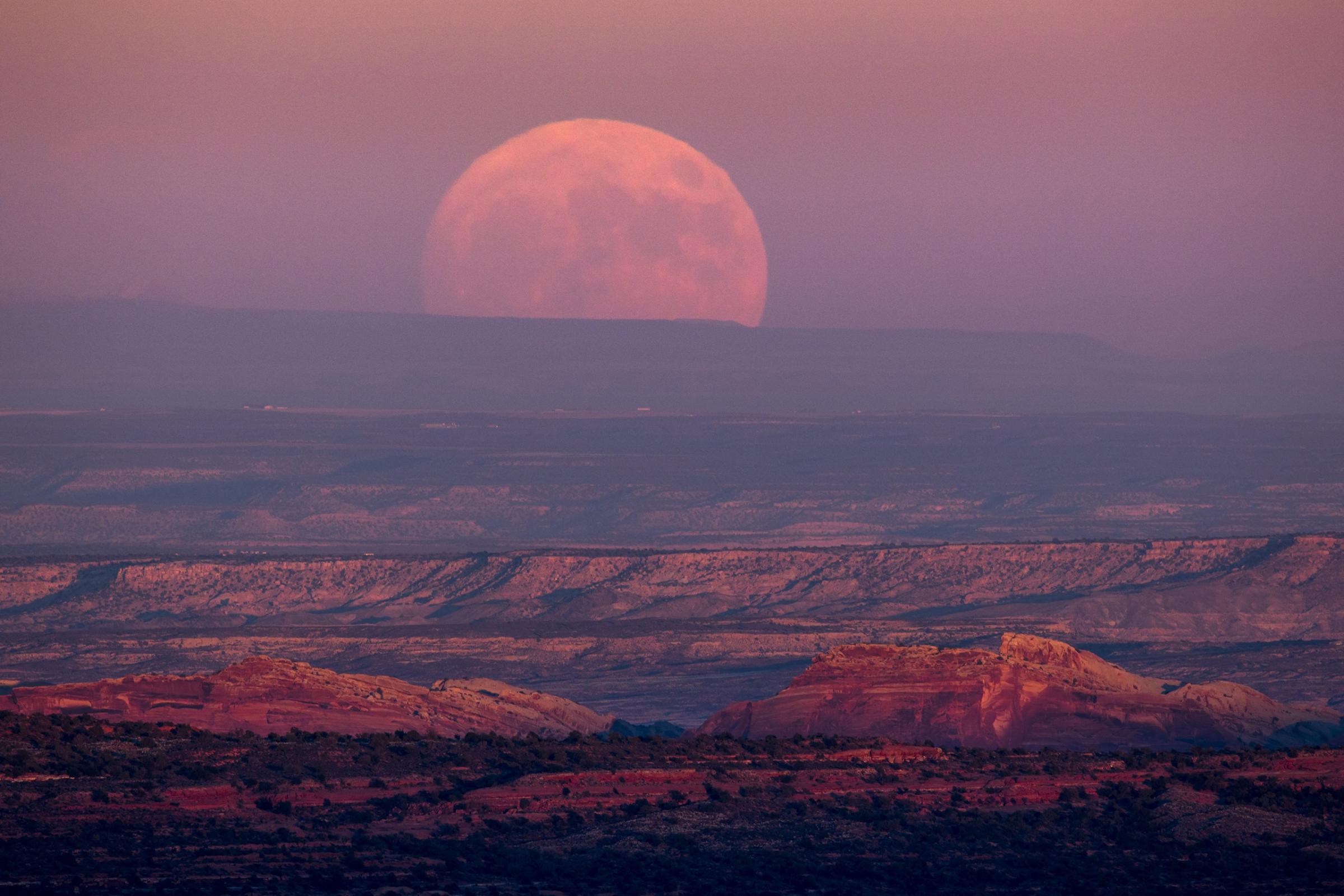 A nearly full moon rises above the Valley of the Gods near Mexican Hat, Utah, on Nov. 13, 2016.