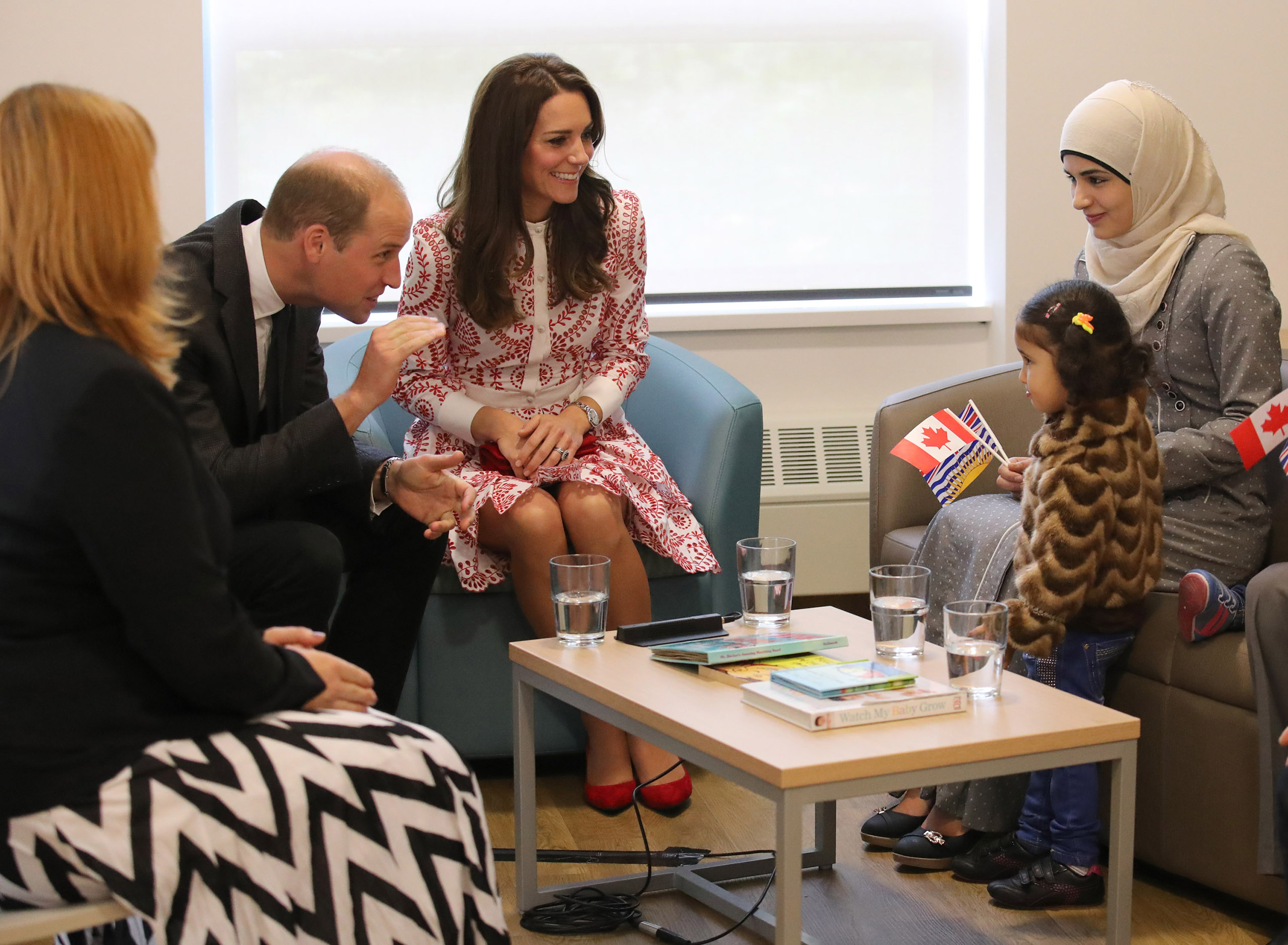 Prince William, Duke of Cambridge, and Catherine, Duchess of Cambridge, with Syrian refugees Yosra Alamahameed and her daughter, Reemus, during their visit to the Immigrant Services Society of British Columbia New Welcome Centre during their Royal Tour of Canada in Vancouver on Sept. 25, 2016.