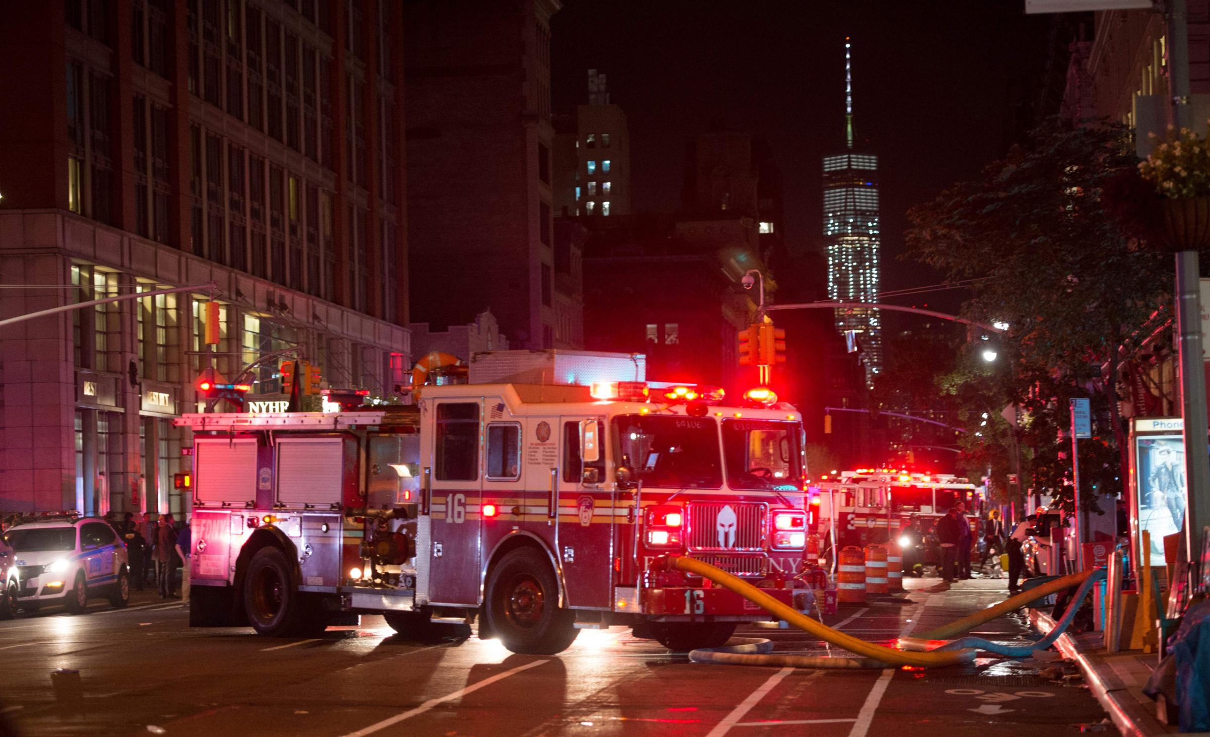 TOPSHOT - A fire truck is seen near a blocked off road near the site of an alleged bomb explosion on West 23rd Street on September 17, 2016, in New York. An explosion in New York's upscale and bustling Chelsea neighborhood injured at least 25 people, none of them in a life-threatening condition, late Saturday, the fire department said. / AFP PHOTO / Bryan R. SmithBRYAN R. SMITH/AFP/Getty Images