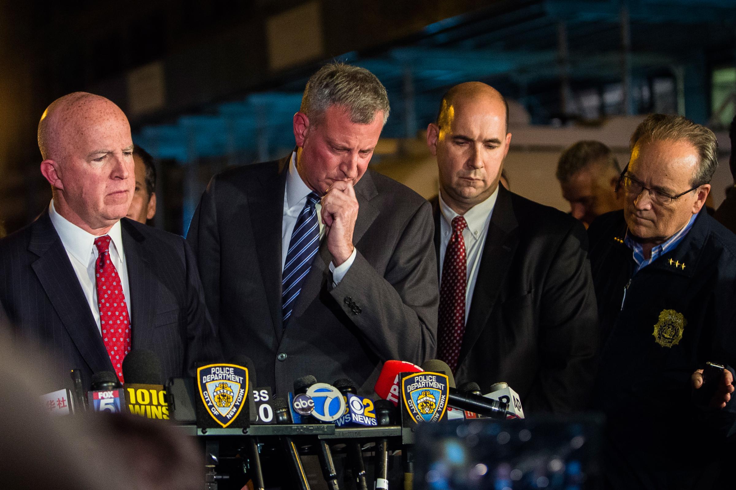 Mayor Bill de Blasio, center, and NYPD Chief of Department James O'Neill, left, react during a press conference near the scene of an explosion on West 23rd street in Manhattan's Chelsea neighborhood, in New York, Saturday, Sept. 17, 2016. Authorities say more than two dozen people were injured in the explosion Saturday night. (AP Photo/Andres Kudacki)