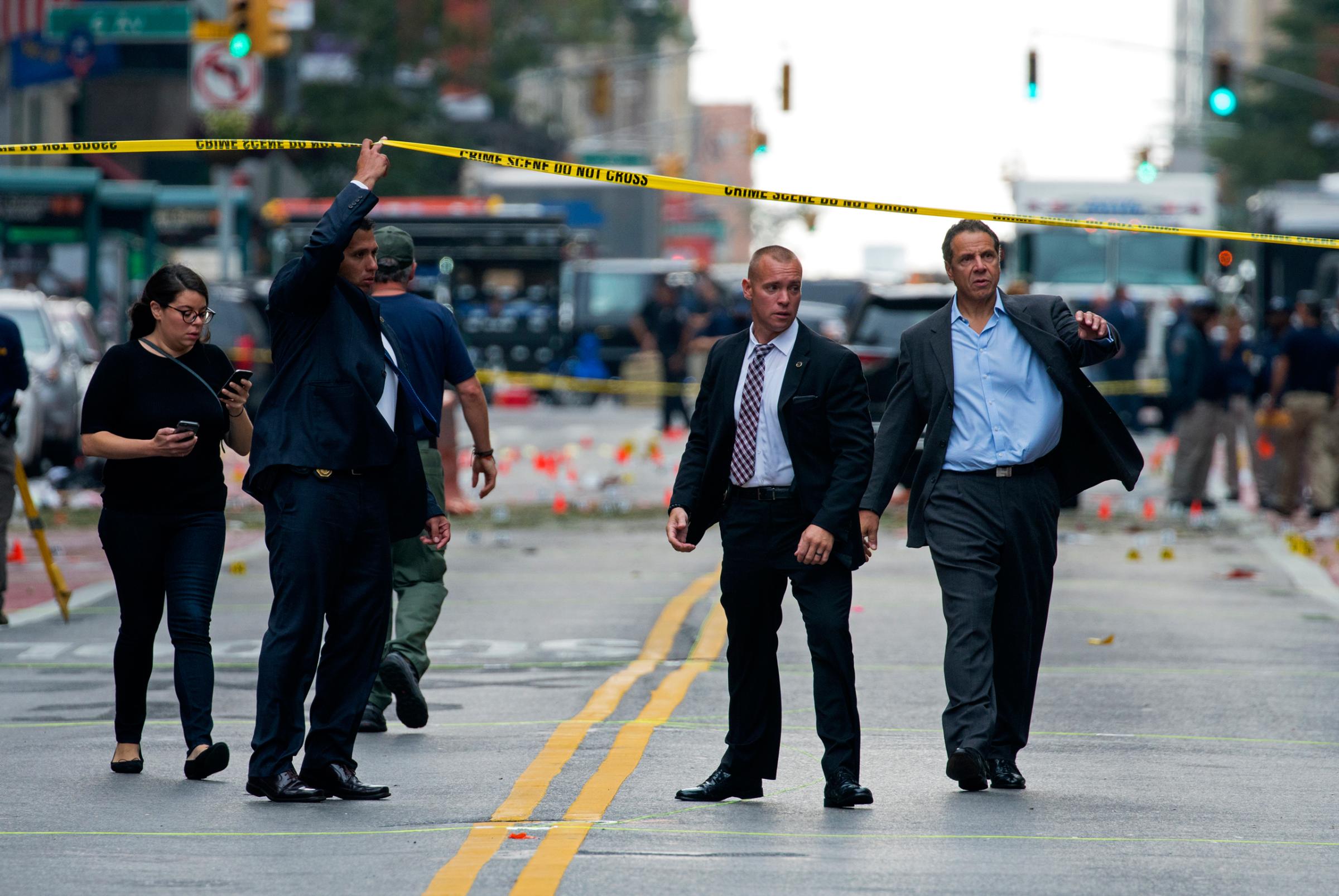 New York Gov. Andrew Cuomo, right, walks from the scene of an explosion in Manhattan's Chelsea neighborhood, in New York, Sunday, Sept. 18, 2016, after an incident that injured passers-by Saturday night. (AP Photo/Craig Ruttle)