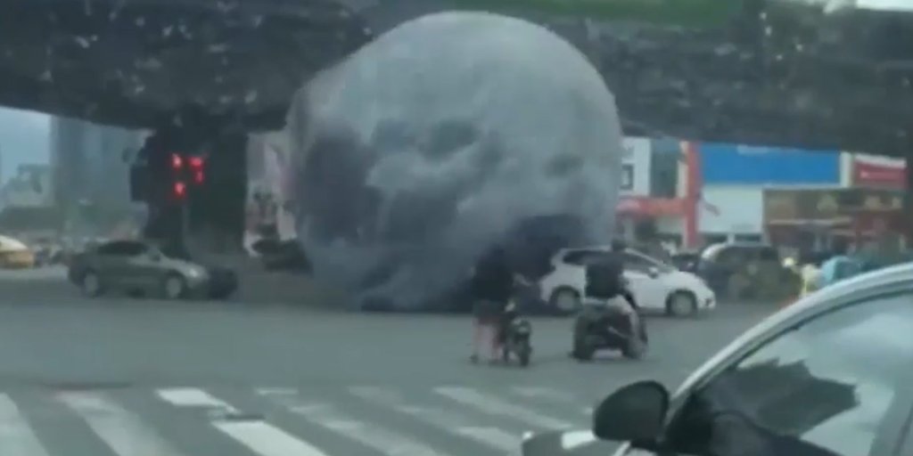 Giant Moon Balloon Rolls Through Traffic In China Time