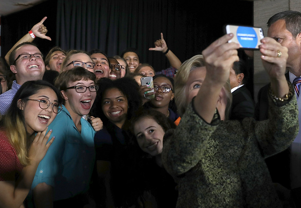 Democratic presidential nominee former Secretary of State Hillary Clinton takes a selfie with supporters after delivering a speech at Temple University on September 19, 2016 in Philadelphia, Pennsylvania.