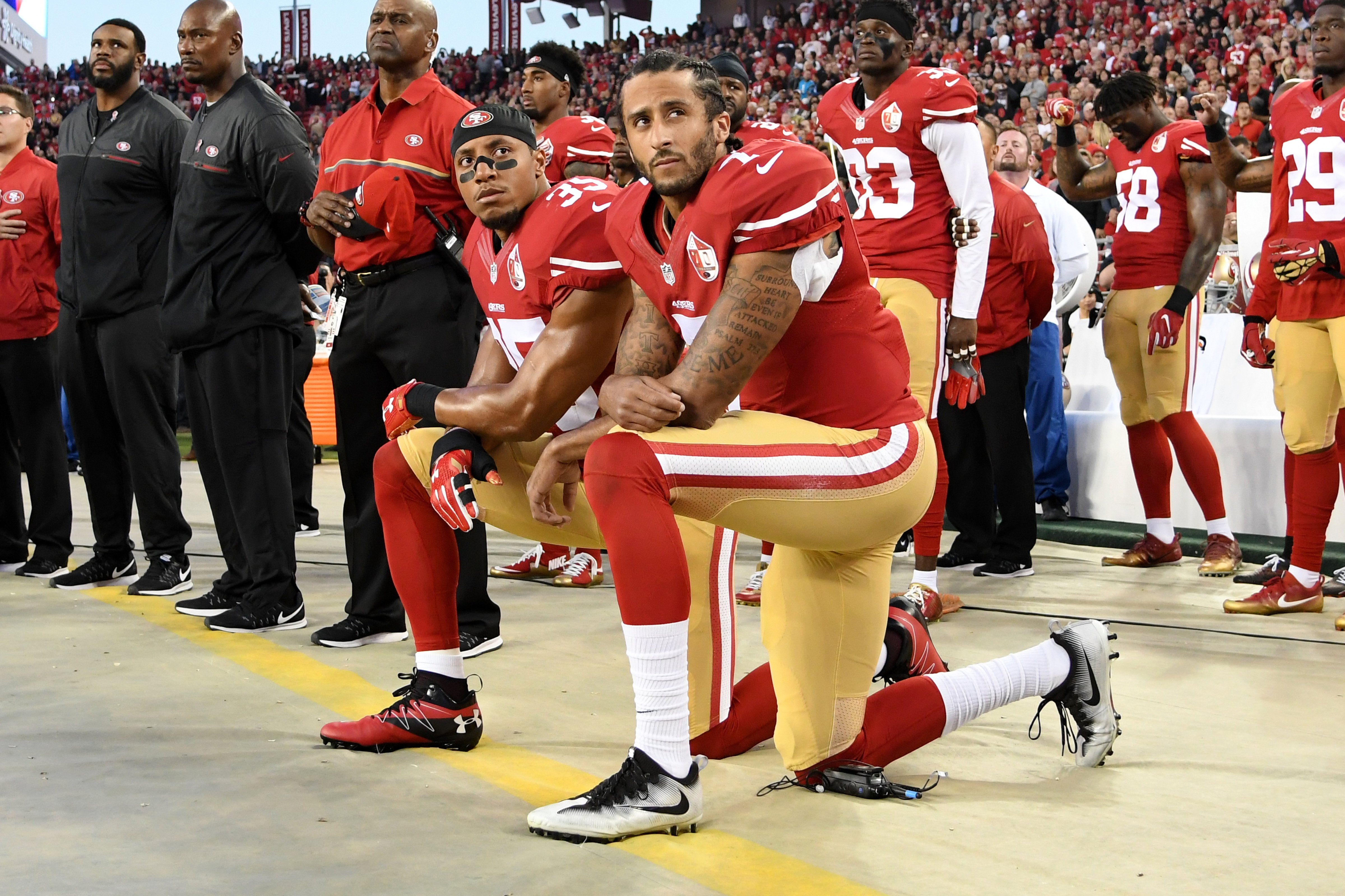 Colin Kaepernick #7 and Eric Reid #35 of the San Francisco 49ers kneel in protest during the national anthem prior to playing the Los Angeles Rams in their NFL game at Levi's Stadium in Santa Clara, Calif., on Sept. 12, 2016. (Thearon W. Henderson—Getty Images)
