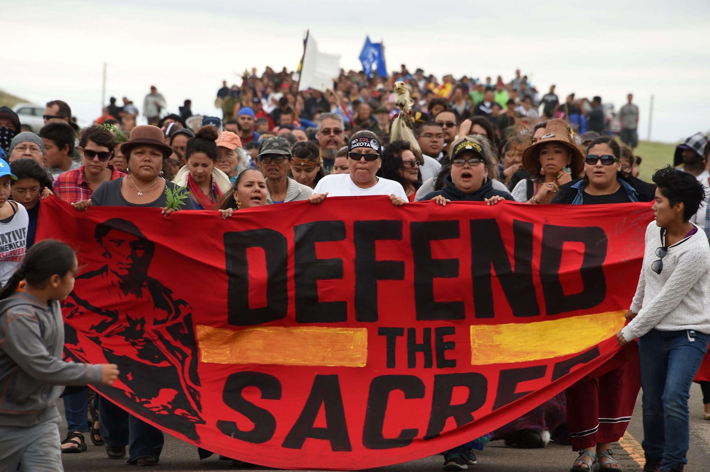 Native Americans march to a burial ground sacred site that was disturbed by bulldozers building the Dakota Access Pipeline (DAPL), near the encampment where hundreds of people have gathered to join the Standing Rock Sioux Tribe's protest of the oil pipeline that is slated to cross the Missouri River near Cannon Ball, North Dakota Sept. 4, 2016.