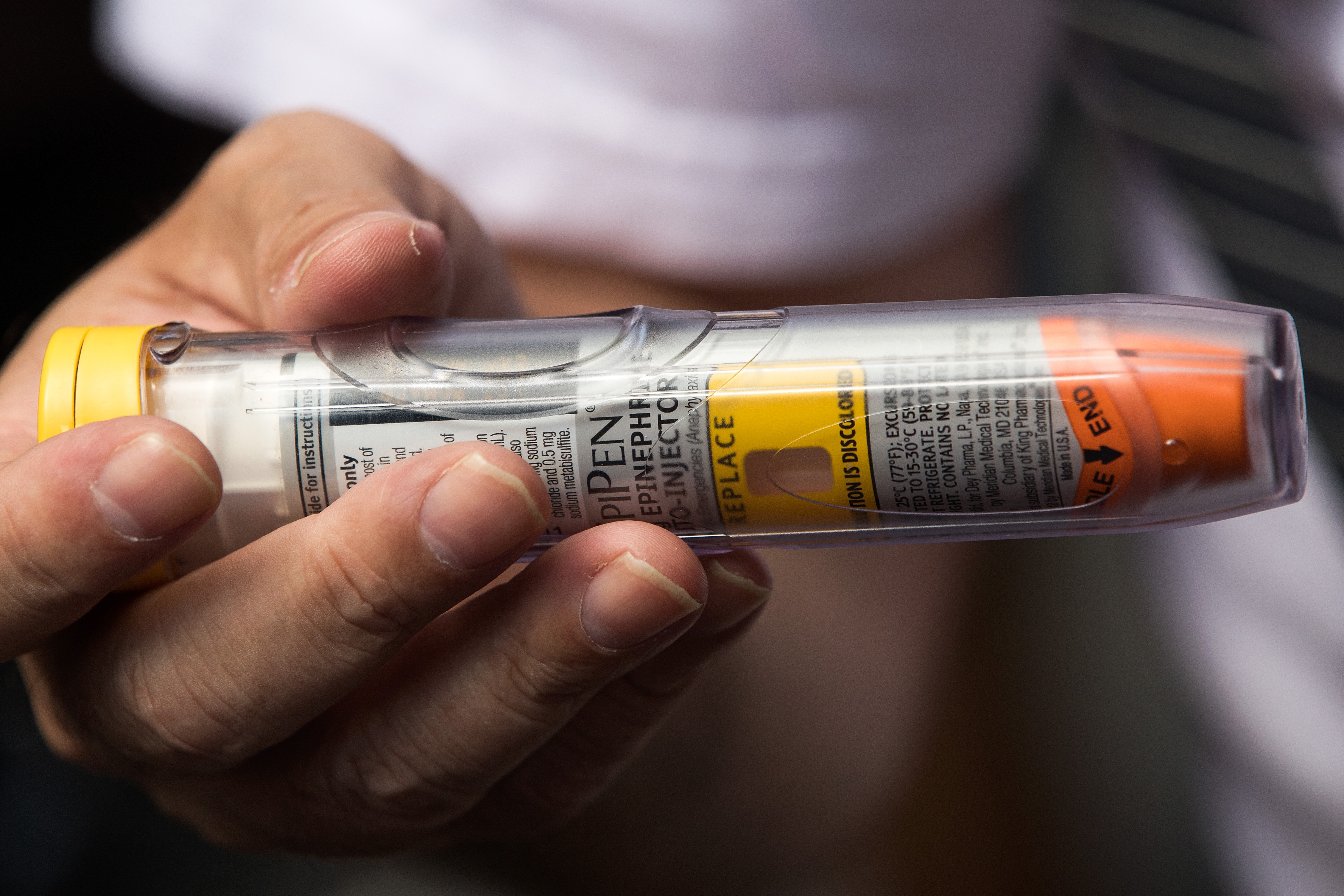 A man who suffers from autoimmune diseases and allergies holds an EpiPen during a protest against the increase in the price of the drug on August 30, 2016 in New York City. (Drew Angerer—Getty Images)