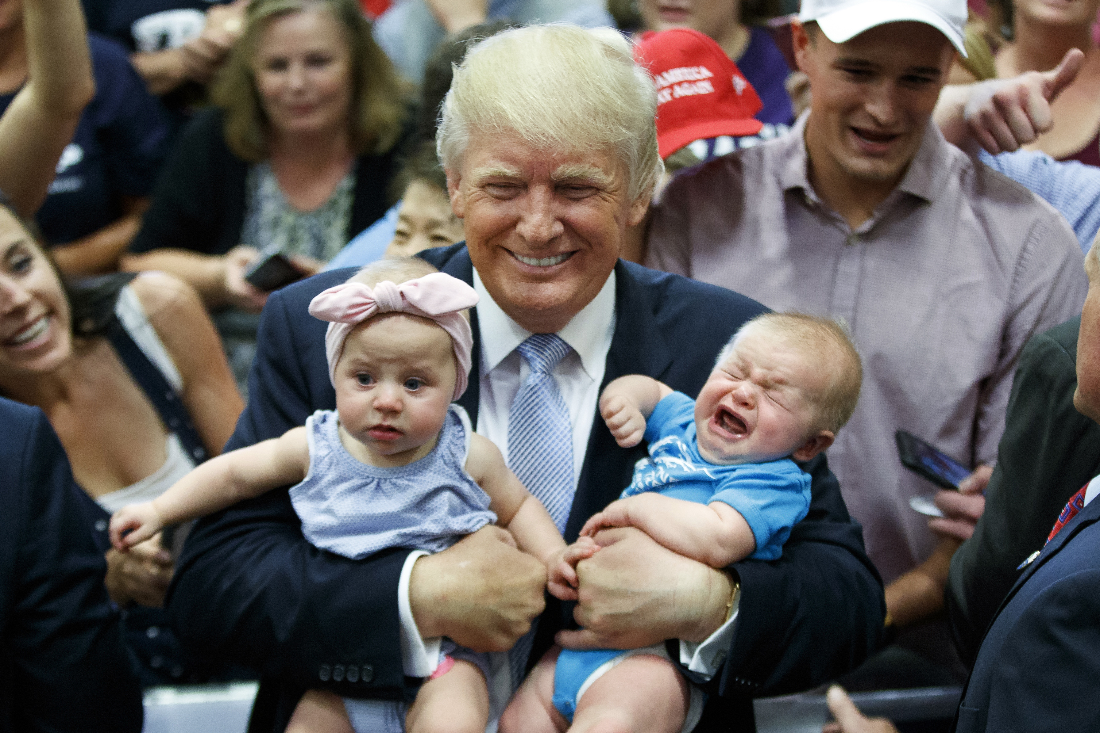 Republican presidential candidate Donald Trump holds a pair of babies as he works the rope line during a campaign rally, July 29, 2016, in Colorado Springs, Colo.