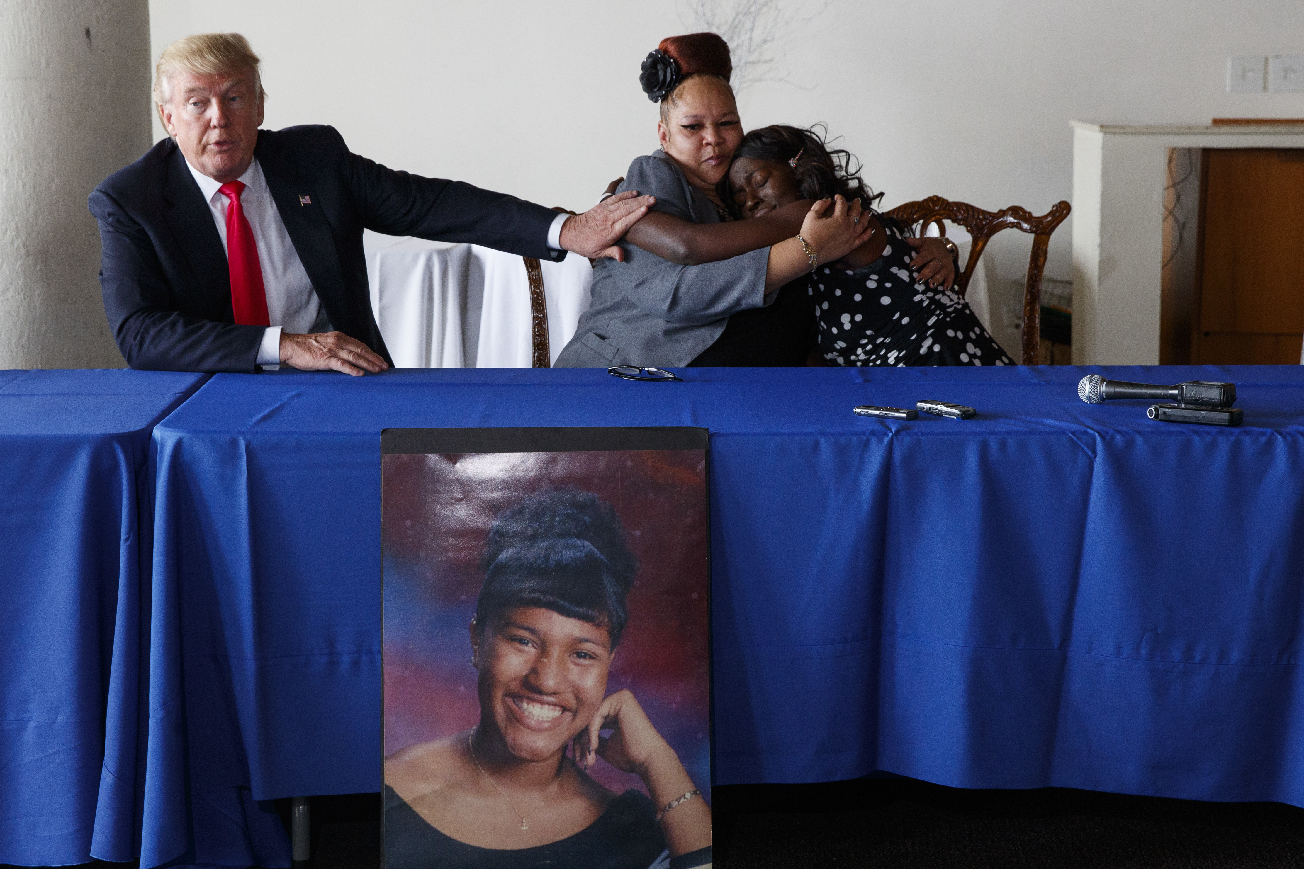 Republican presidential candidate Donald Trump comforts Shalga Hightower, center, as she hugs family spokesman Charmil Davis, Sept. 2, 2016, in Philadelphia. Hightower's daughter, Iofemi Hightower, was murdered in a 2007 attack at a Newark schoolyard.