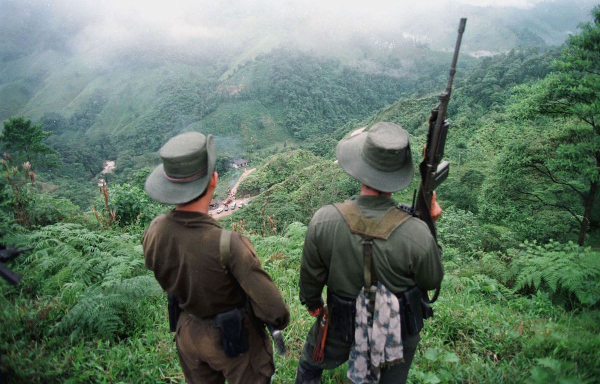 Two armed soldiers belonging to the Revolutionry Armed Forces of Colombia (FARC) monitor the Berlin pass, in Colombia in 1998. (Pedro Ugarte—AFP/Getty Images)