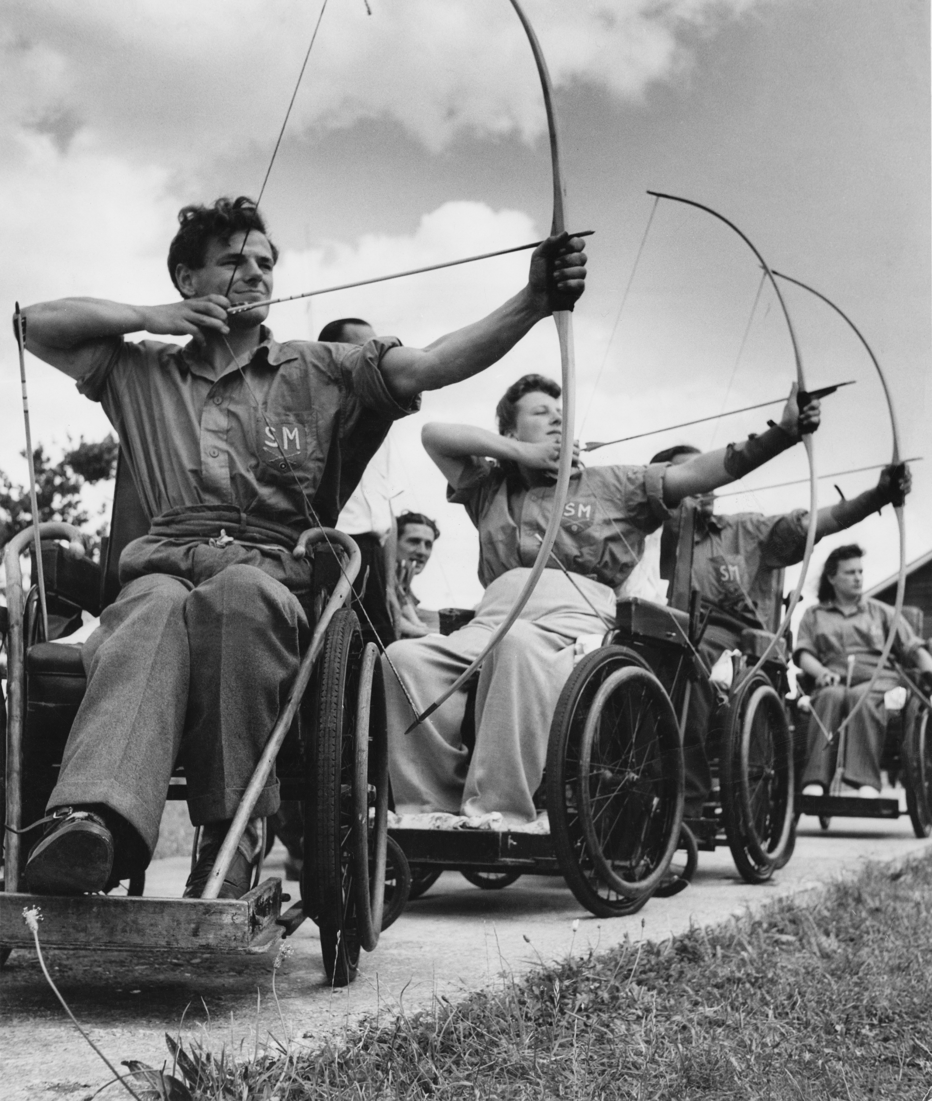 An archery class at the Ministry of Pensions Spinal Centre at Stoke Mandeville Hospital, Buckinghamshire, UK, 1949. (Raymond Kleboe/Picture Post—Getty Images)