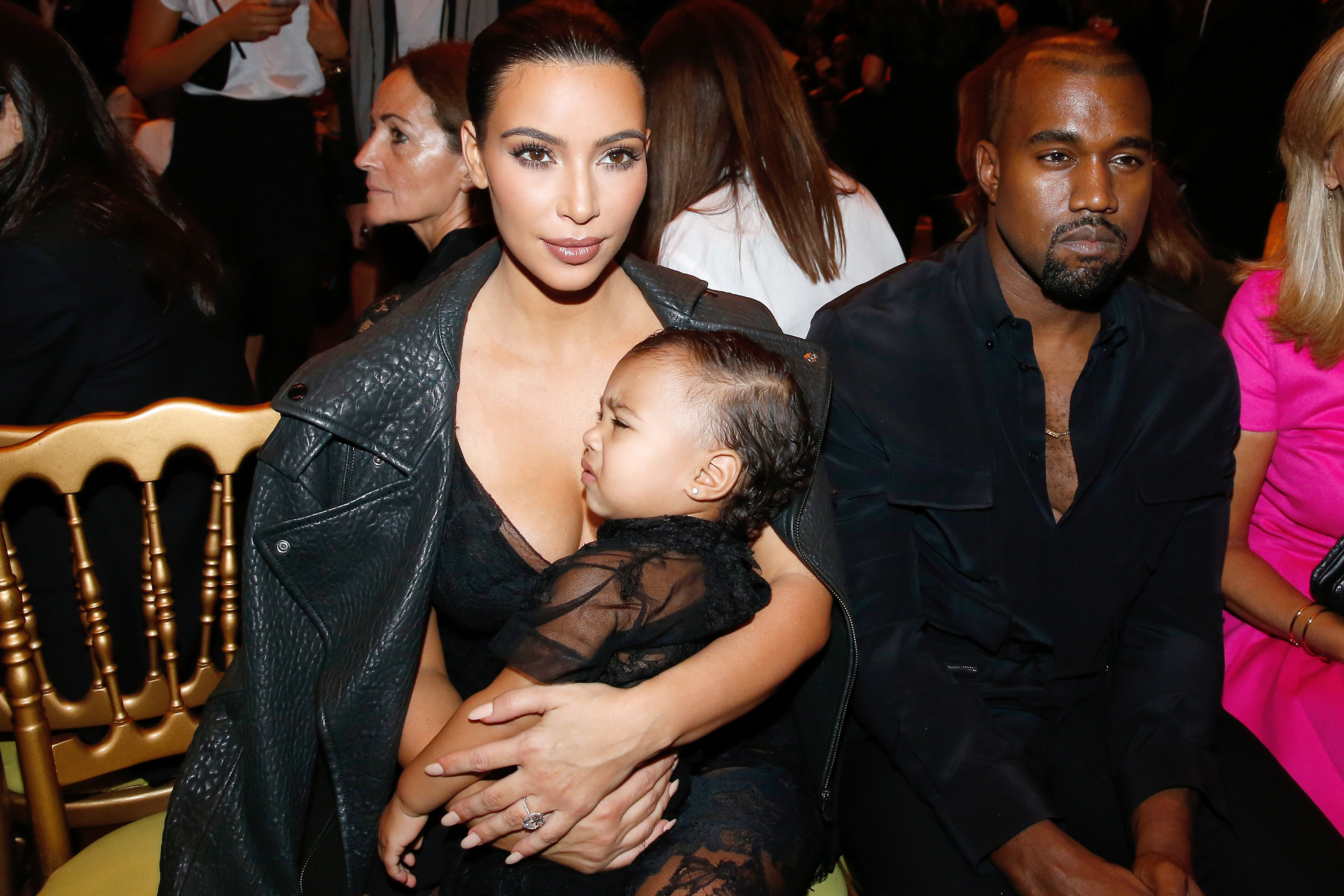 Kim Kardashian, Kanye West and their daughter North West at the Givenchy Spring/Summer 2015 fashion show.