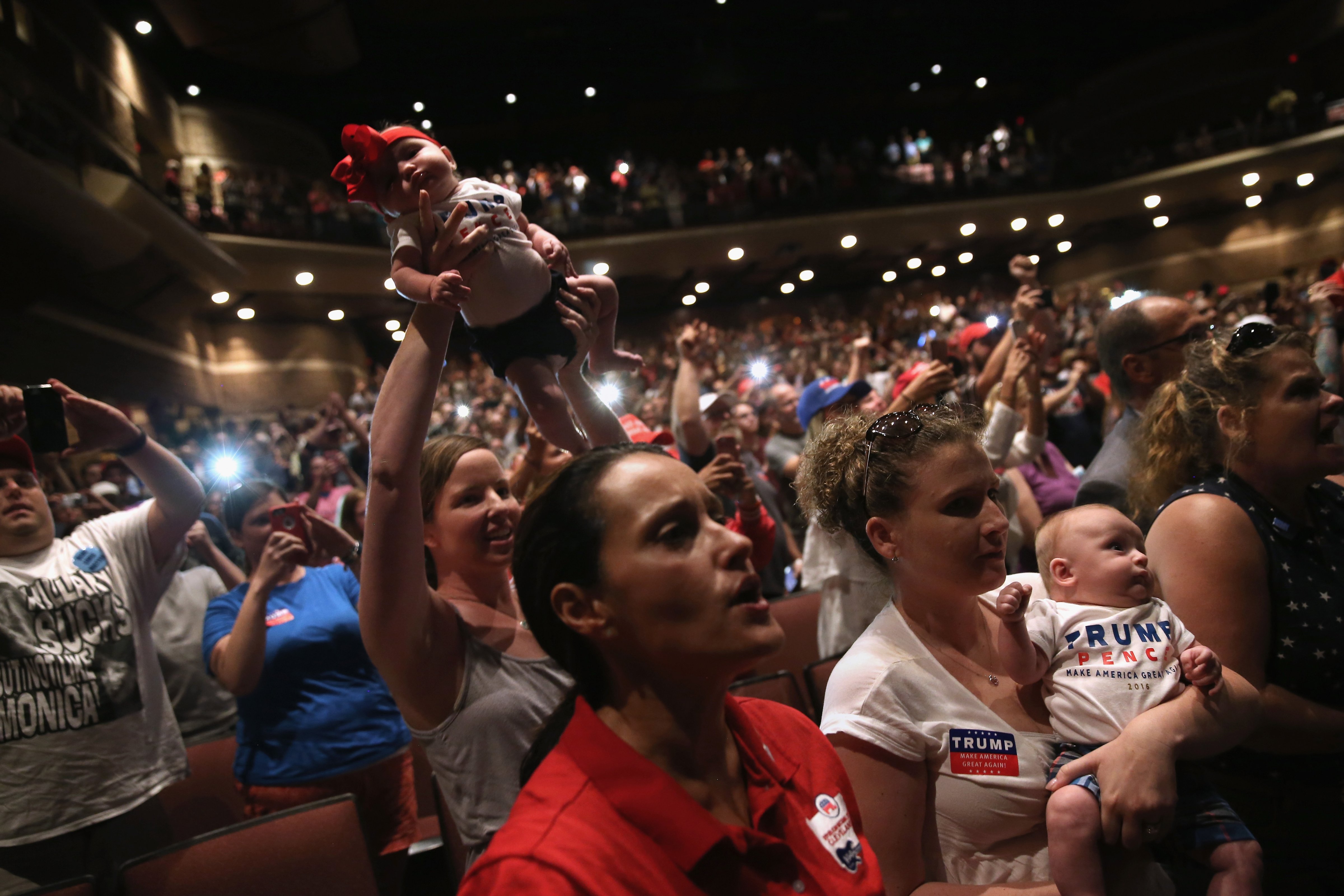 Women hold up their babies festooned for Republican Presidential nominee Donald Trump as he speaks at a campaign rally in Mechanicsburg,  on August 1, 2016. (John Moore—Getty Images)