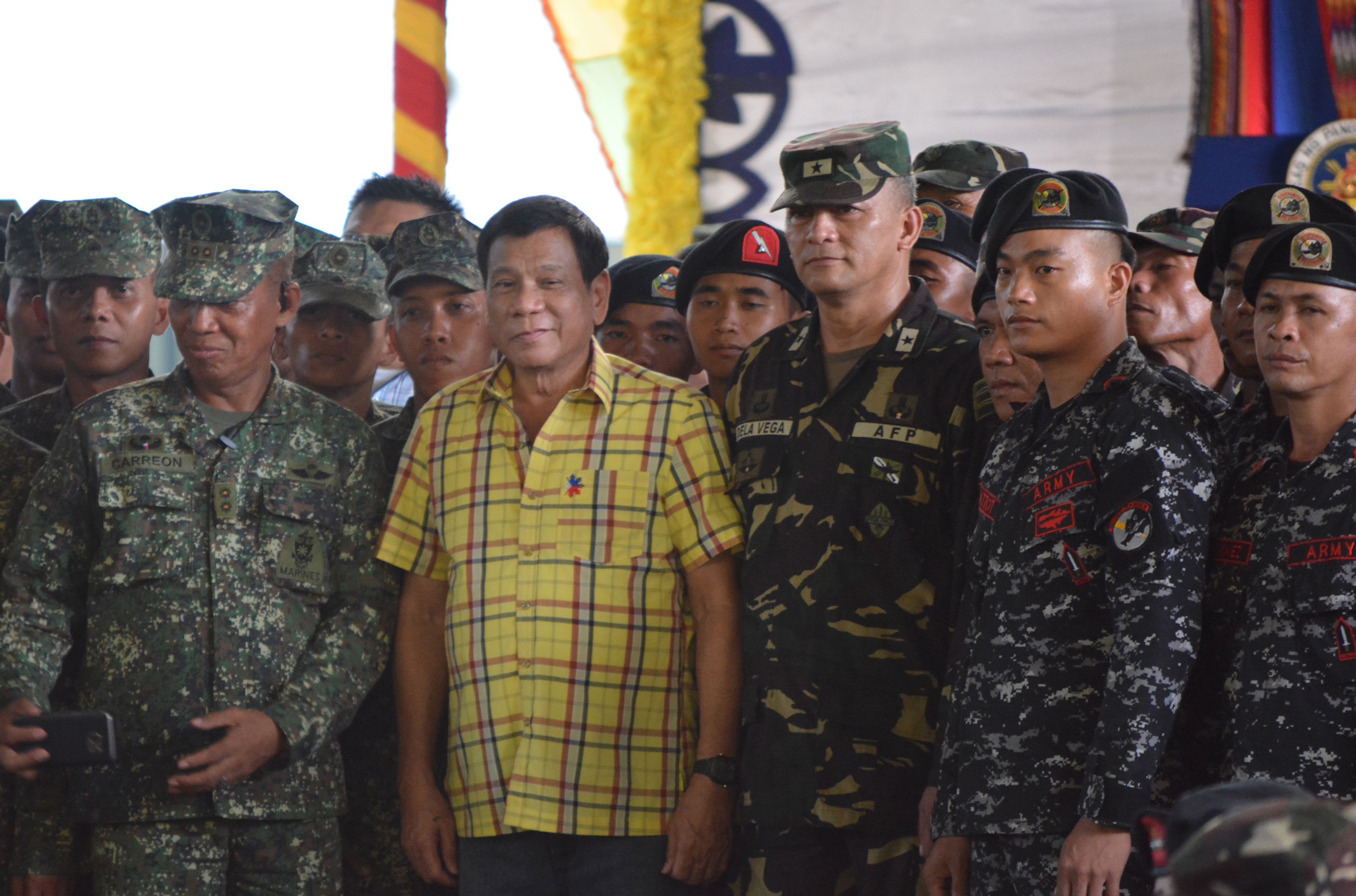 Philippine President Rodrigo Duterte, center left, poses with military personnel during a visit to a military camp in the Philippine town of Jolo, Sulu province, in the southern island of Mindanao, on Aug. 12, 2016 (STR—AFP/Getty Images)