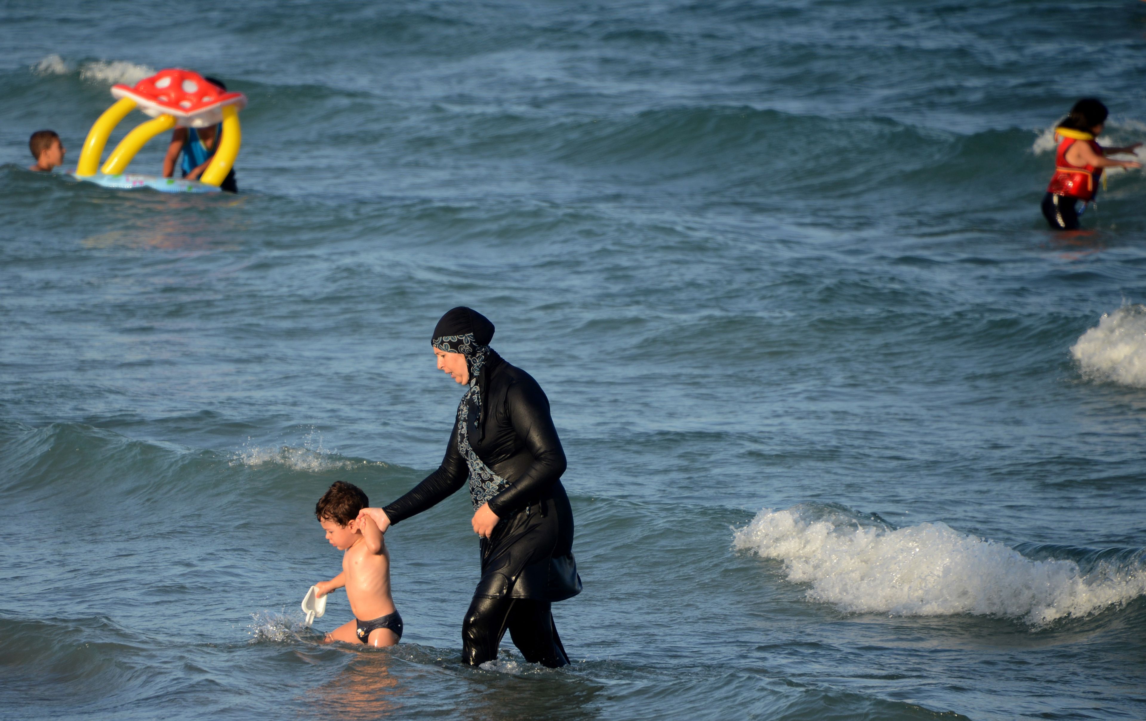 A Tunisian woman wearing a burkini, a full-body swimsuit designed for Muslim women on Aug. 16, 2016, at a beach northeast of Tunis (Fethi Belaid—AFP/Getty Images)